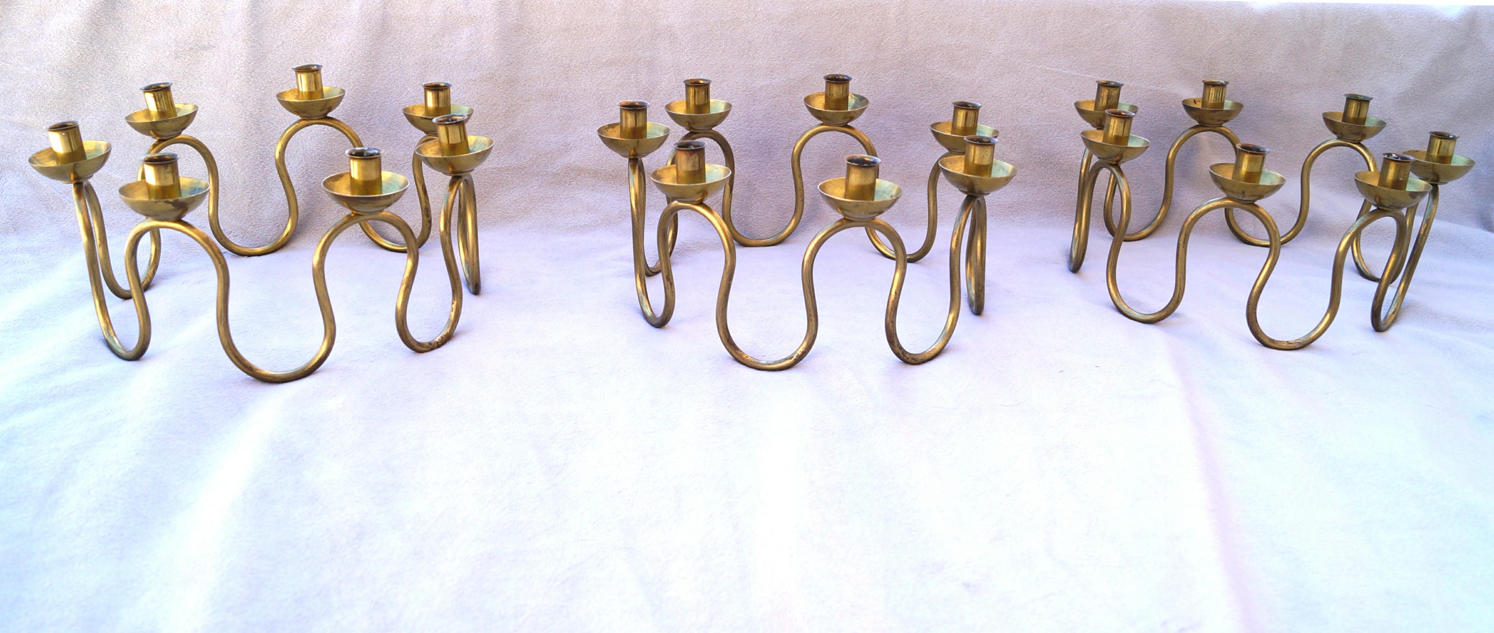 This set of 3 Holmström candlesticks are a beautiful addition to any  décor , particularly during the Swedish tradition of Lucia. Made by Lars Holmström in Arvika . These candlesticks are made of brass with rounded stems , designed to fit slim small