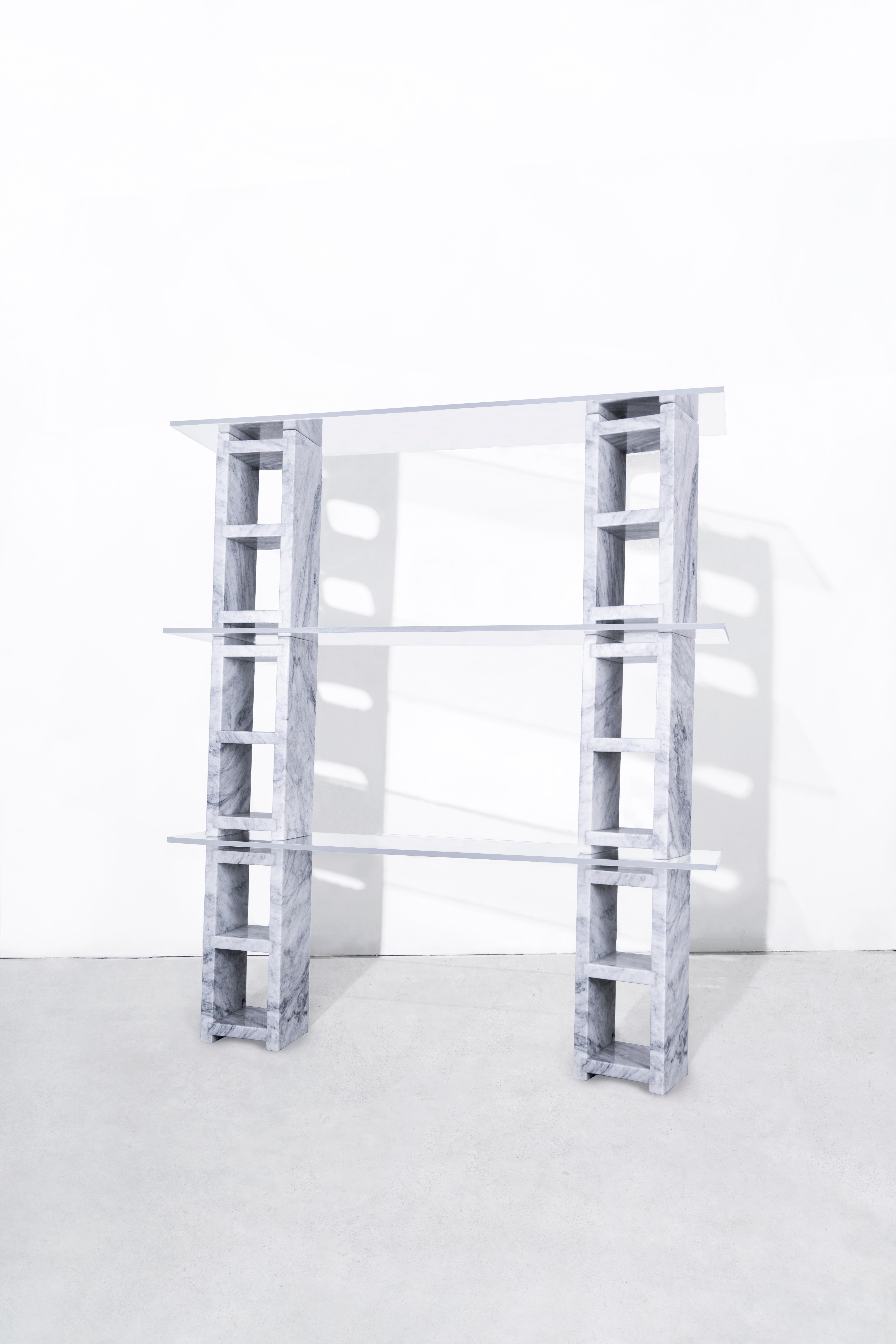 DESCRIPTION
6 water jet cut, hand-polished carrara marble blocks, supporting 3 tempered glass shelves.
Starphire glass shelves.
Modular.
Made to order in nyc.

DIMENSIONS
Cinder Block length 18.75?
Cinder block width 7.5” 
Cinder block