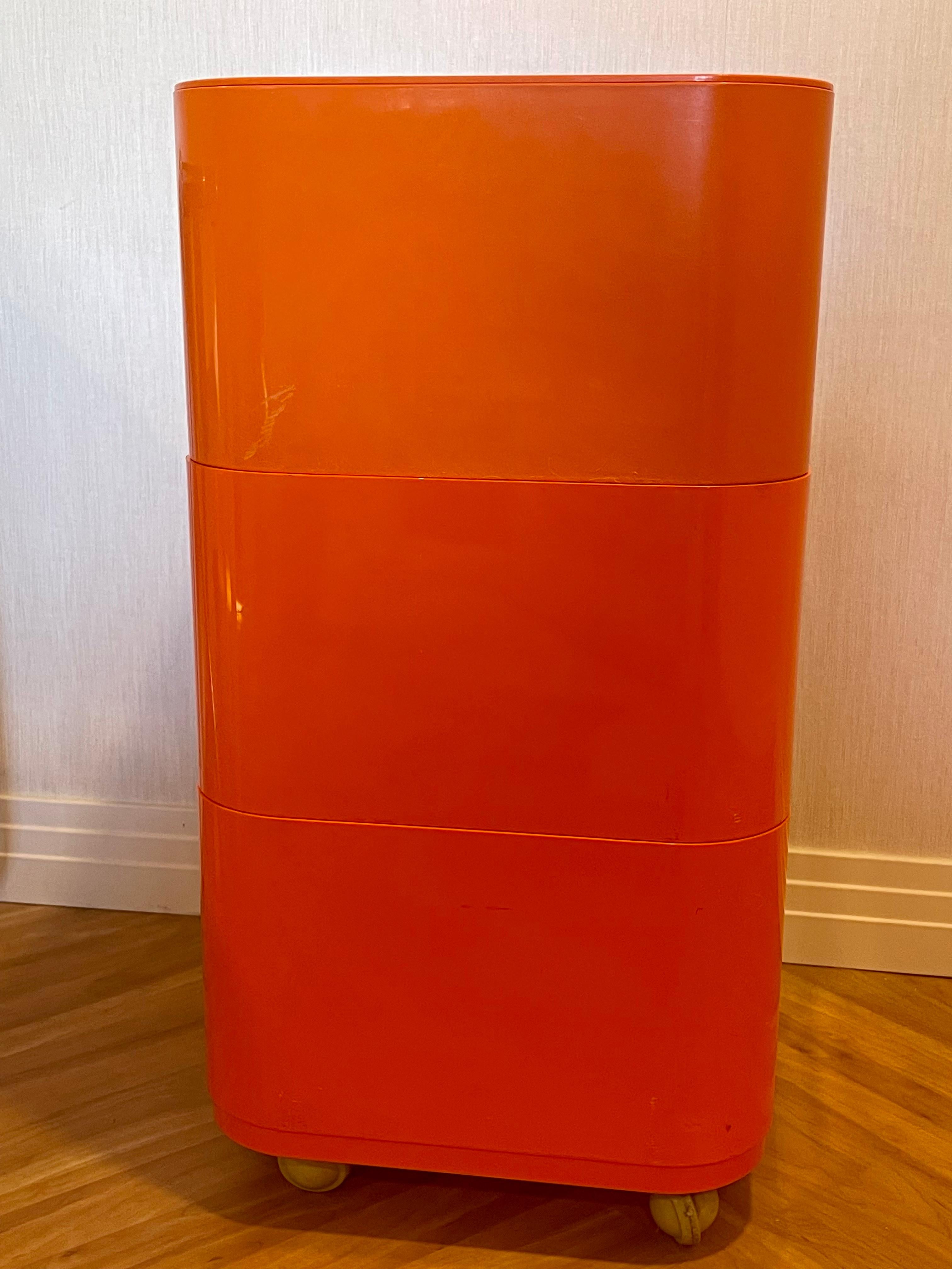 3-Tier vintage square compinibili on casters in very rare orange abs plastic by iconic designer and Kartell co-founder Anna Castelli Ferrieri. Some scuffing and light scratching to sides.