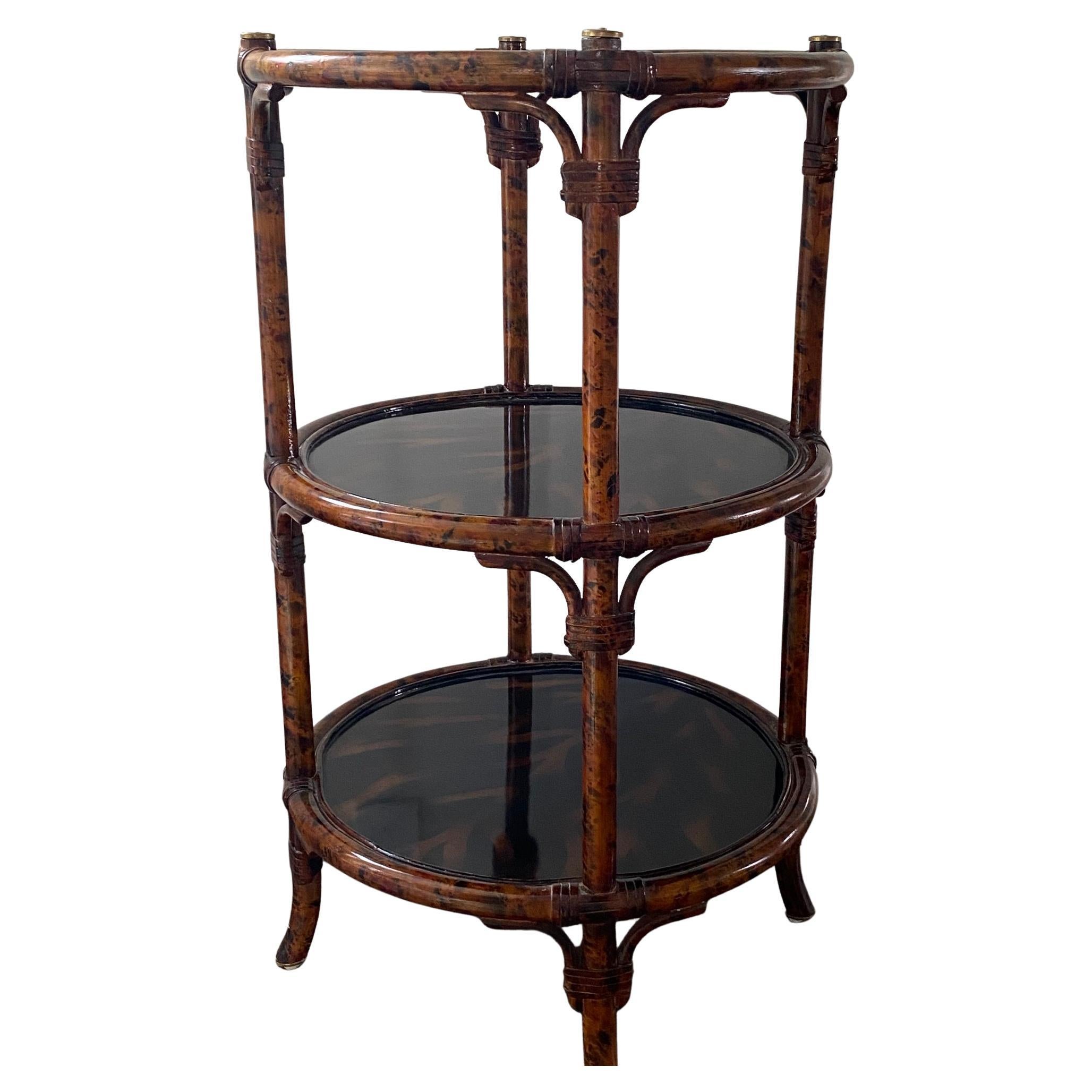 Rich looking highly lacquered round 3-tier faux tortoise and bamboo end table having handsome rattan wrapping the joints and 4 round brass medallions around the periphery.
10.25 bottom tier to middle tier
11