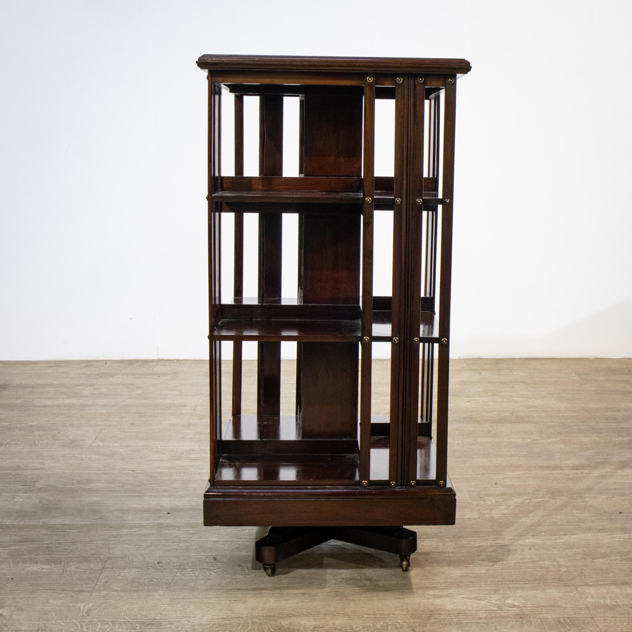 A useful mahogany revolving bookcase which has been recently restored and refinished, this piece stands on a four footed pedestal base with brass castors, so it is easy to move around. The top of the three tiers has shaped vertical spindle