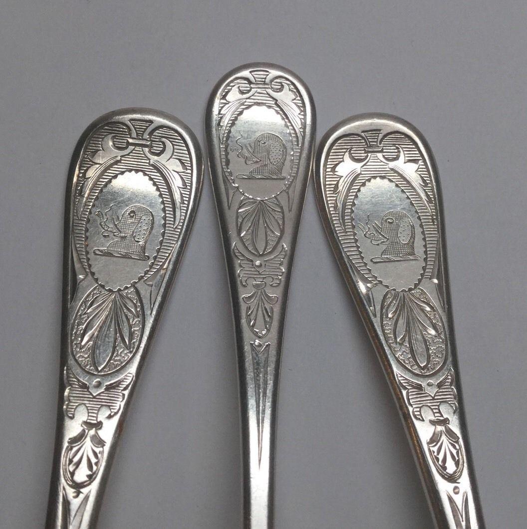 Tiffany & Co. sterling silver spoons in the 1870 King William Engraved pattern. 
Marked: m TIFFANY & CO. STERLING. 
Monogrammed on back handle: CH. 
Front engraving is of an elephant head. 
1 teaspoon 6