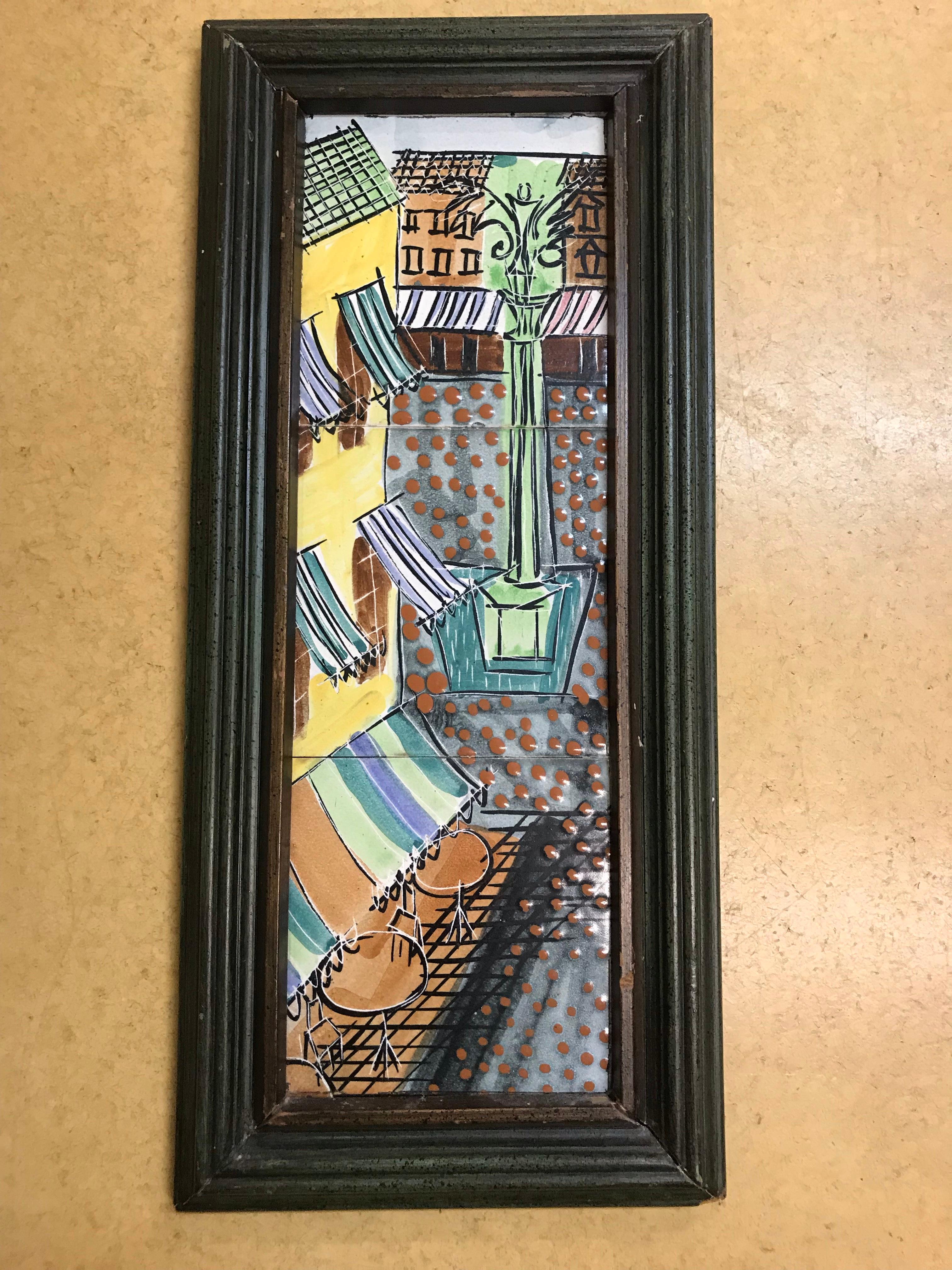 Cafe street scene in green, yellow, blue, and brown glazes. Early tile done by Harris Strong in original frame.
