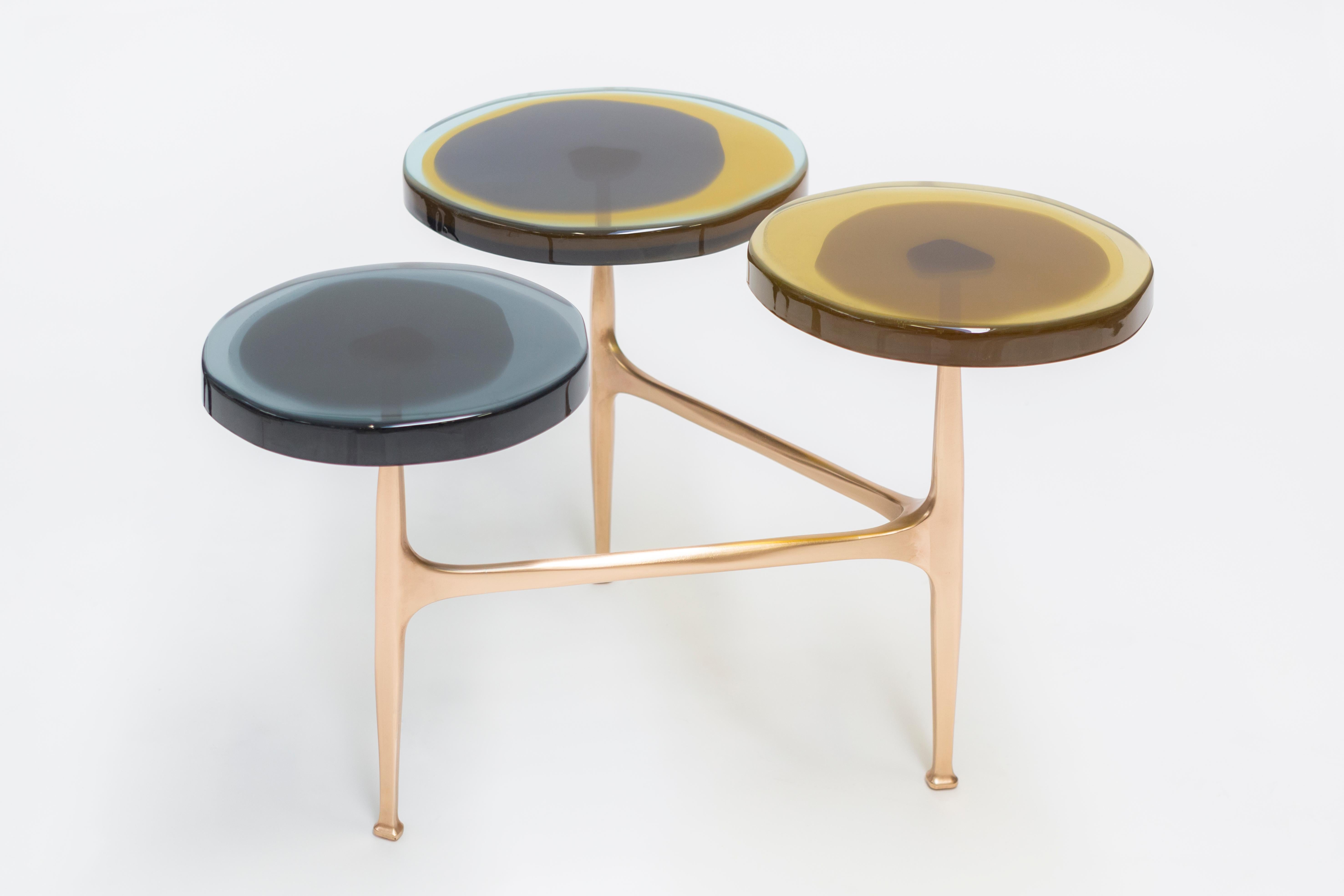 Agatha coffee table by Draga & Aurel
Dimensions: W 121 x D 80 x H 50 cm
 top Ø 32/40 cm
Materials: Resin, bronze

The Agatha coffee tables are featured by irregular circular tops of transparent and
colorful resin sit on a bronze frame with a