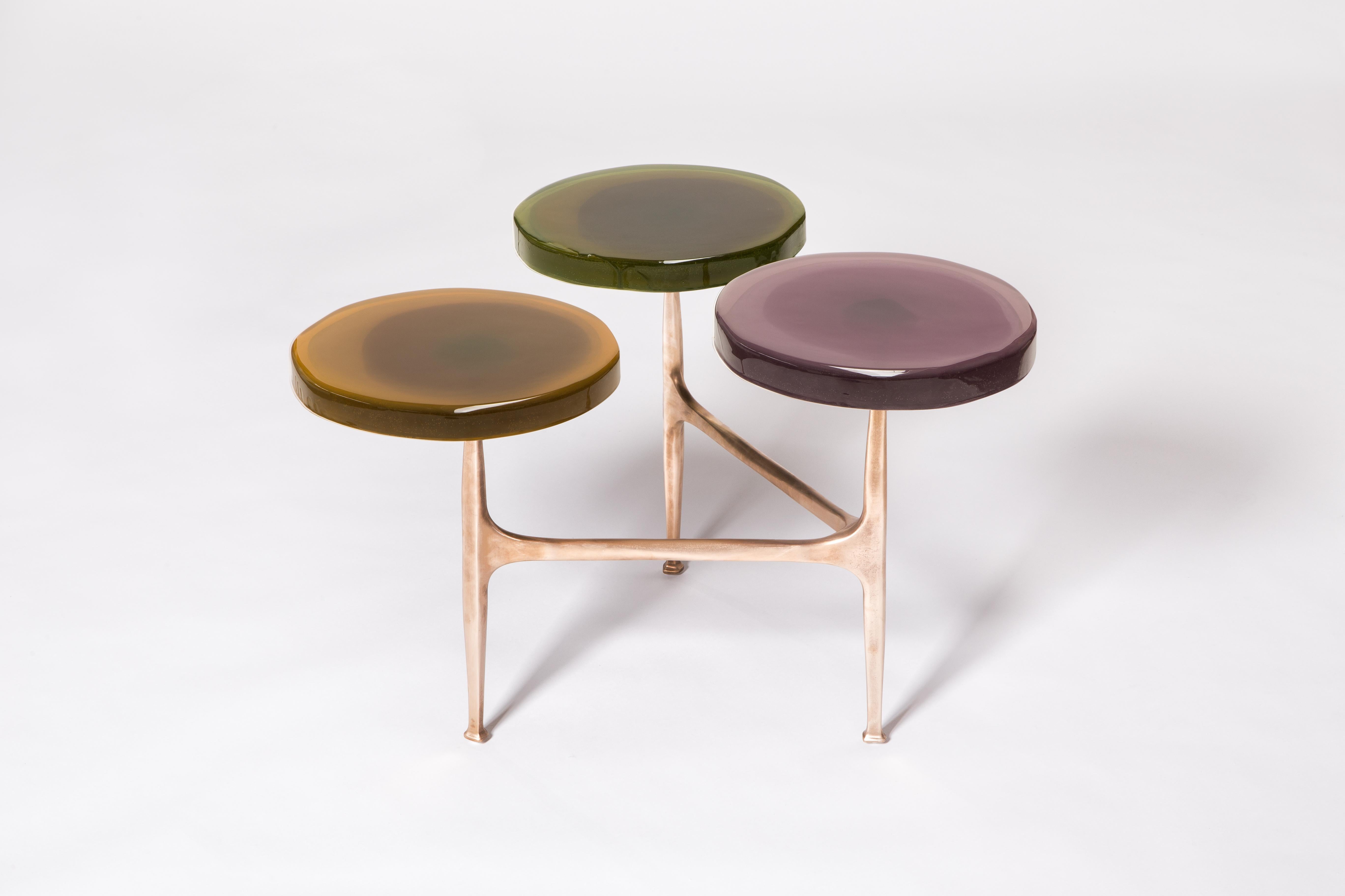 3 Tops Agatha coffee table by Draga & Aurel
Dimensions: W 121 x D 80 x H 50 cm
 Top Ø 32/40 cm
Materials: Resin and bronze

The Agatha coffee tables are featured by irregular circular tops of transparent and
colorful resin sit on a bronze frame with