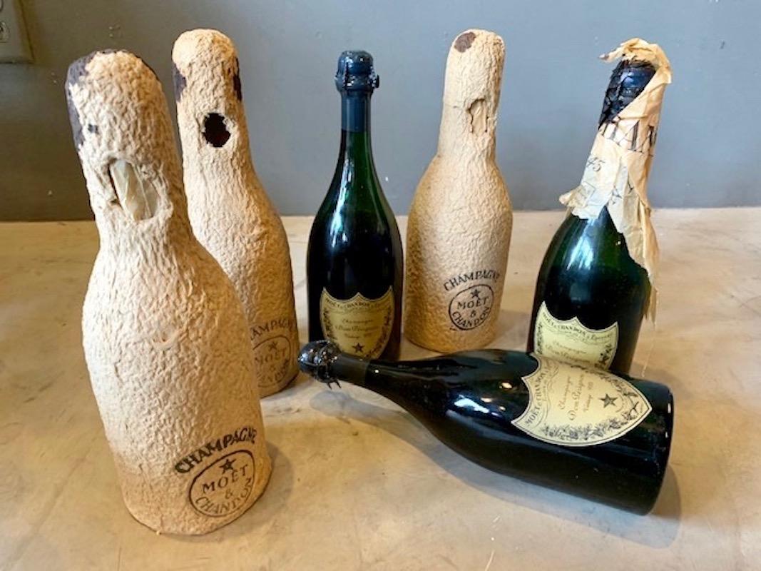 Three bottles of Dom Perignon or Moet et Chandon. Two are dated 1952 and one 1955. Include original tissue paper and bottle covers. I assume these wouldn't be tasty to drink. Interesting vintage find and great for a bar.