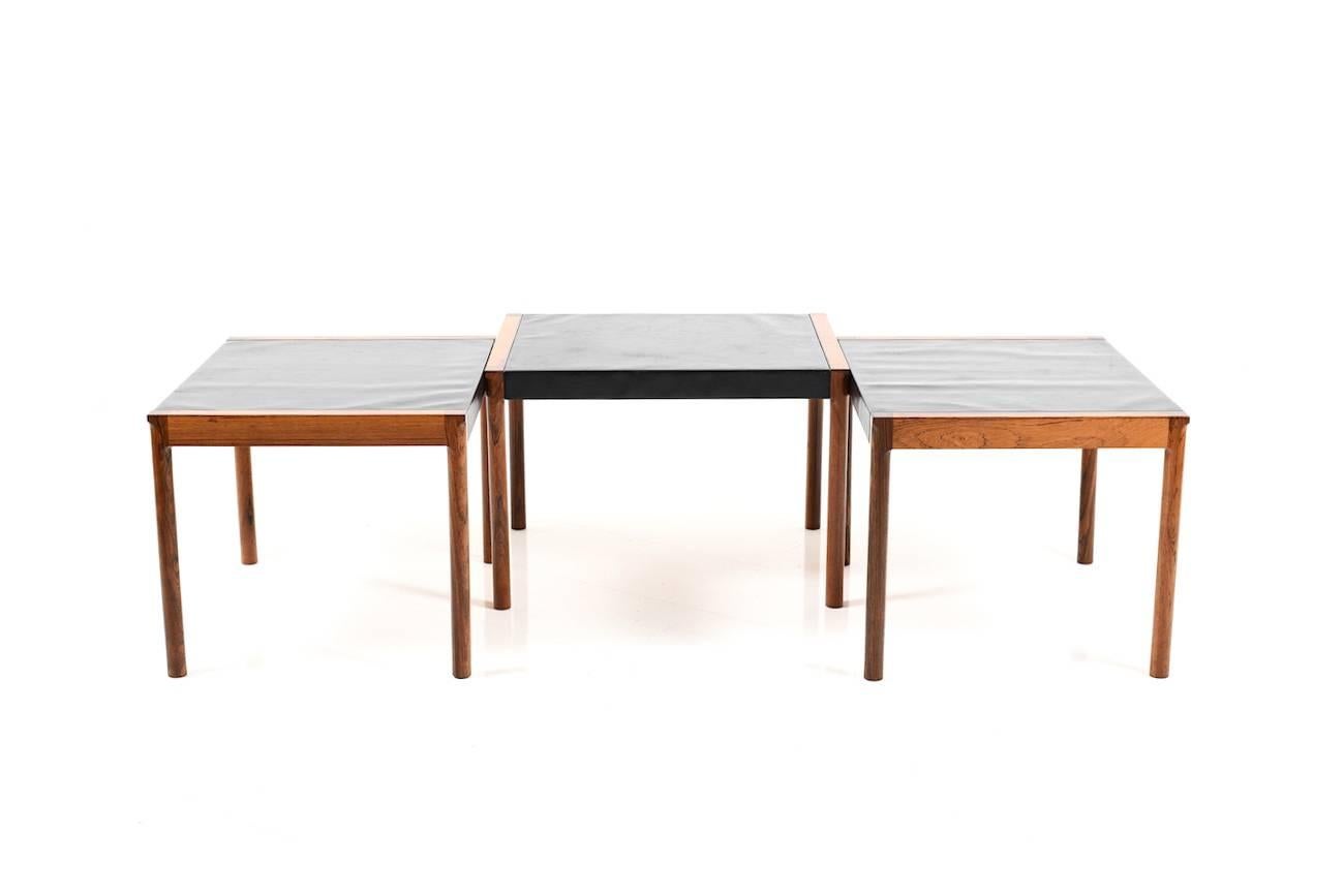 Three variable Danish sofa tables in rosewood. Plates in black imitation leather. Made in Denmark early 1960s.