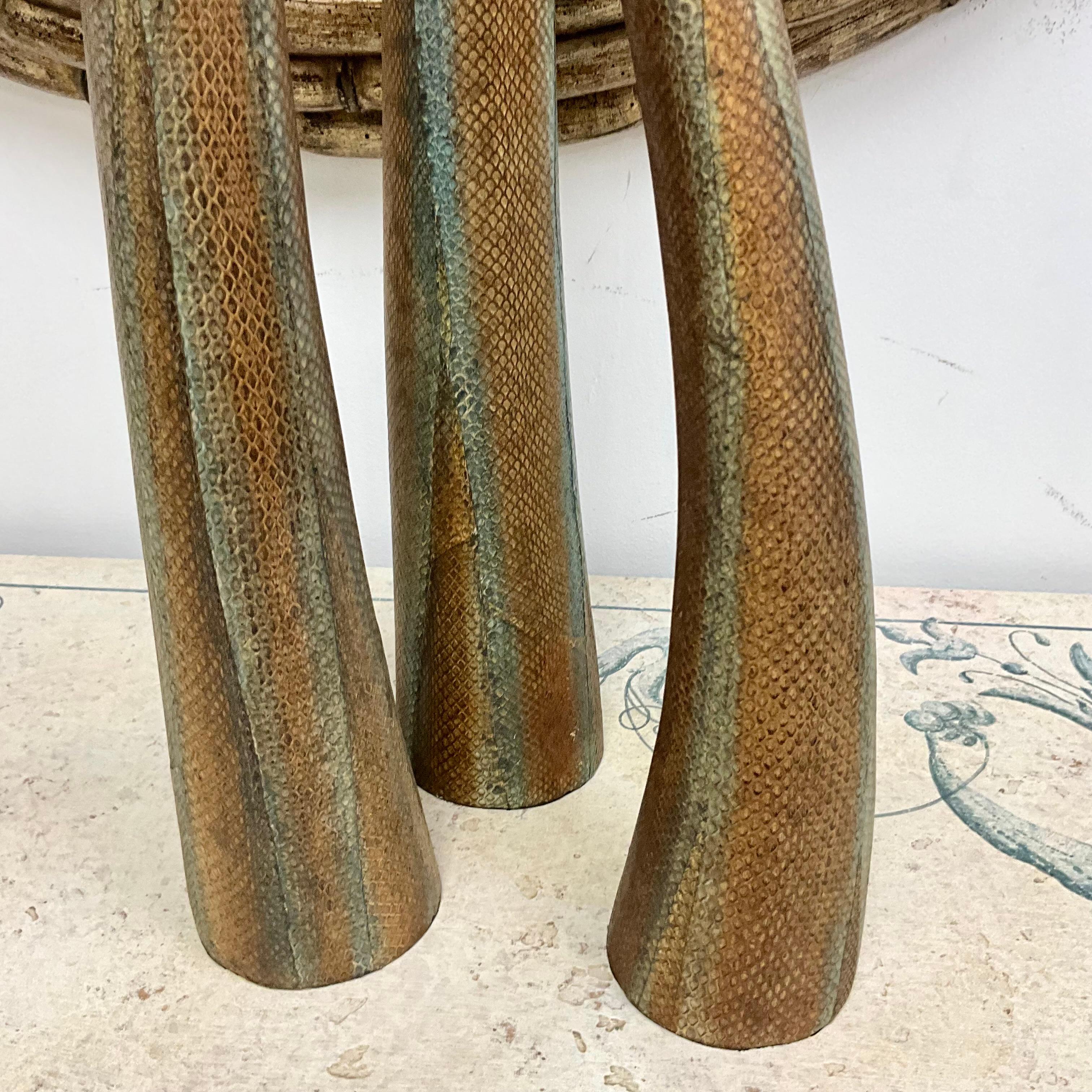 Set of three vases covered in hand painted snakeskin in graduating heights ranging from 29.5” x 28’ x 18.5”.  All three vessels have a diameter of 4”.  The vases have been artist hand painted in varying earthtone organic colors of browns and light