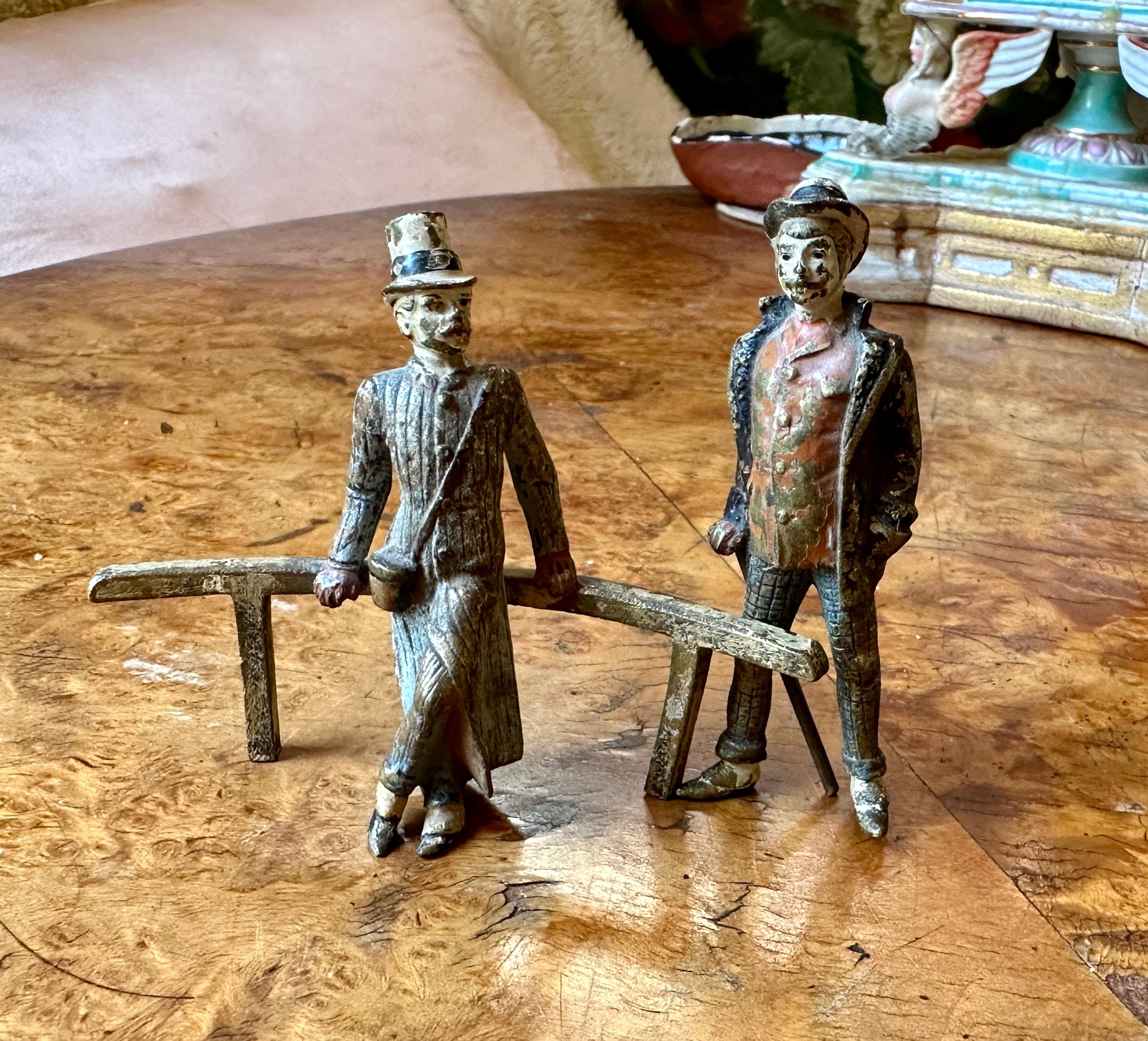 THIS IS A SUPERB AND VERY RARE TRIO OF THREE VICTORIAN - EDWARDIAN GENTLEMEN.  THE BRONZE SCULPTURES ARE CHARMING ANTIQUE AUSTRIAN VIENNA BRONZE.  THE THREE MEN LOUNGE AS IF IN A PARK, ONE LEANING ON A RAILING.  THEIR FACES, CLOTHES, POSES AND