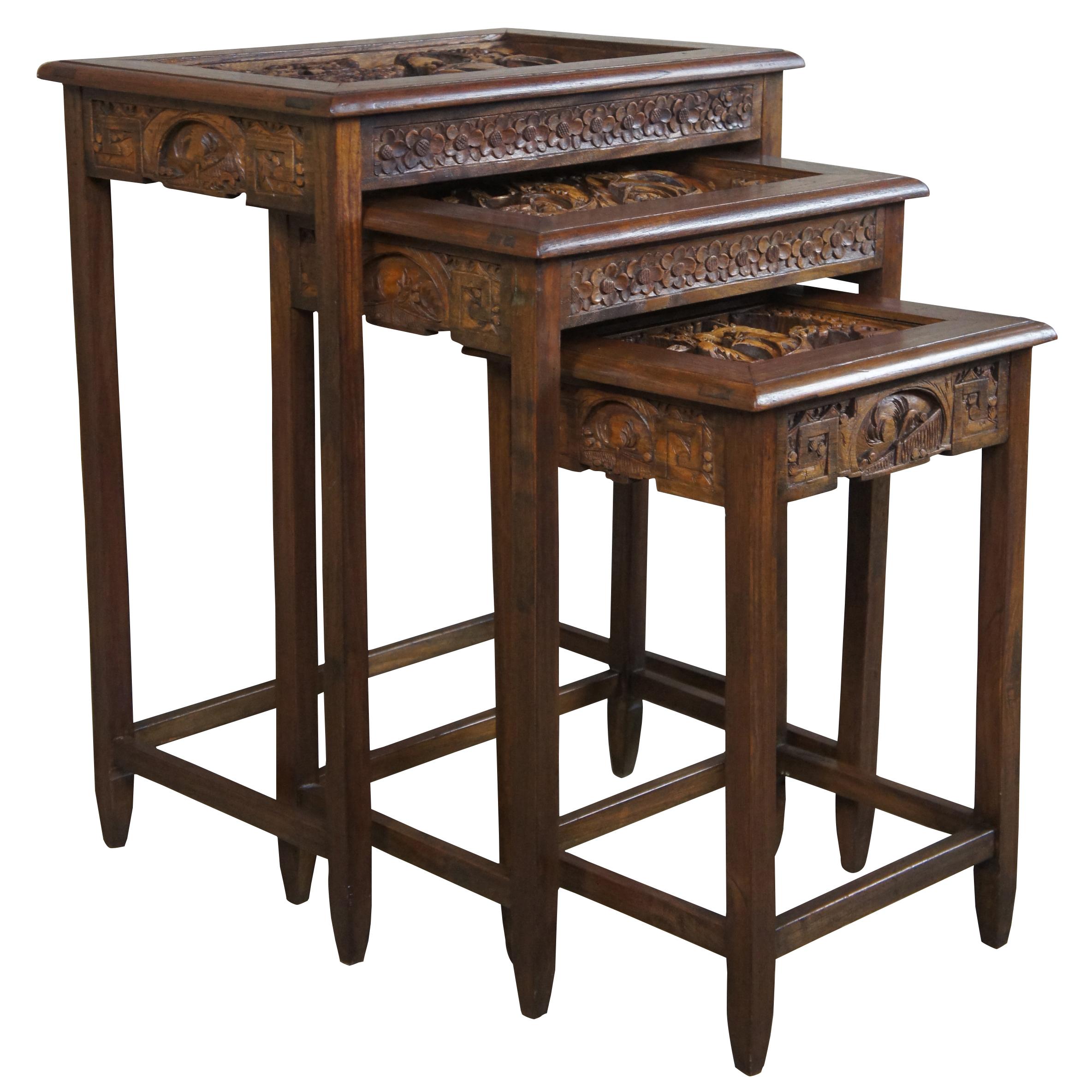 Set of three Chinese rosewood nesting tables. Each features an inset top with high relief boat and ocean scene. Additional features cherry blossom and chinoiserie carved apron. Each successive table has one more ship carved, so the smallest has one