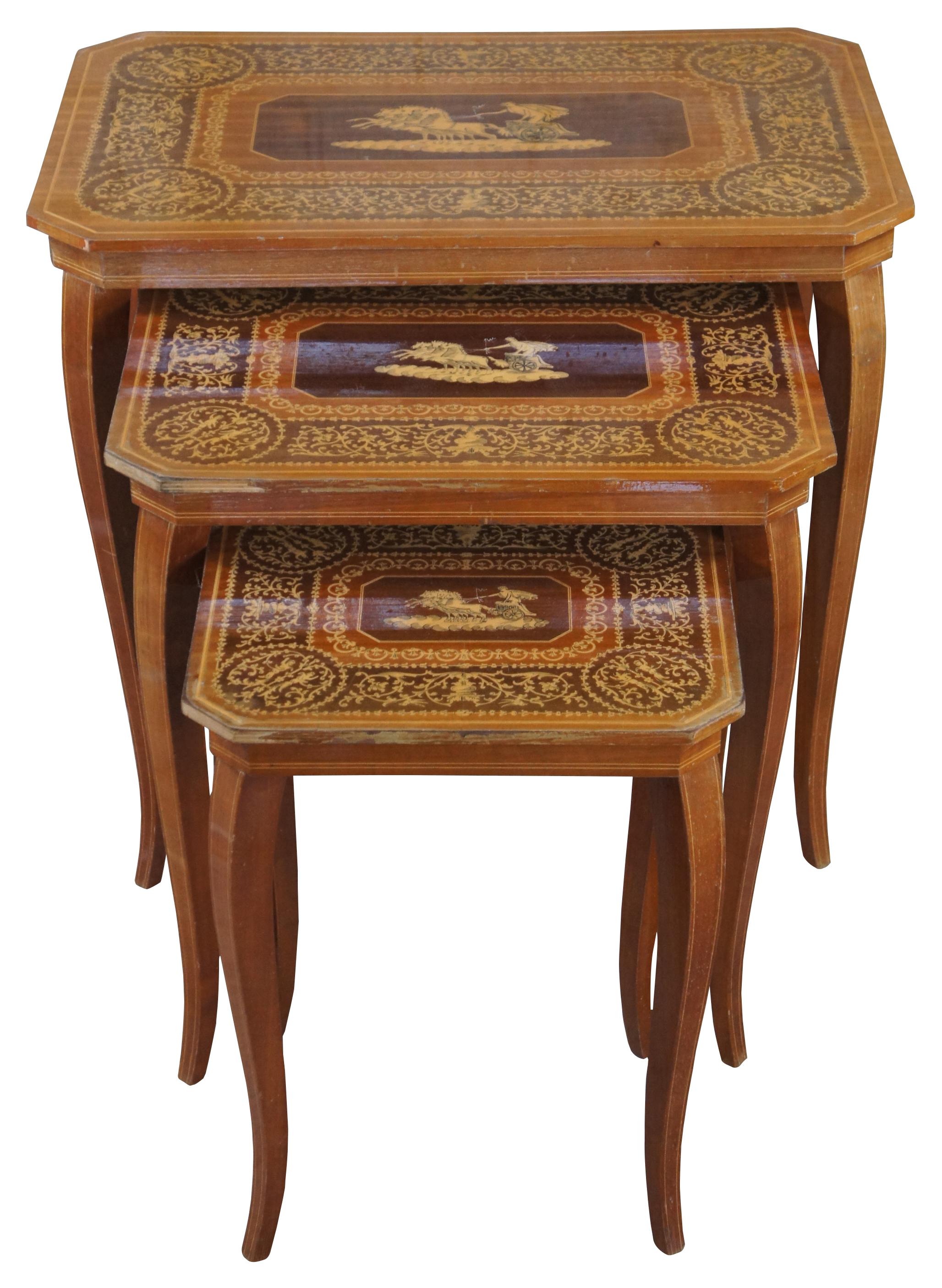 Three vintage Italian Neoclassical nesting tables featuring rectangular form with central scene composed of a four horse drawn chariot and ornate banding with cherubs, trophy urns and floral motifs.

Measures: 18.5