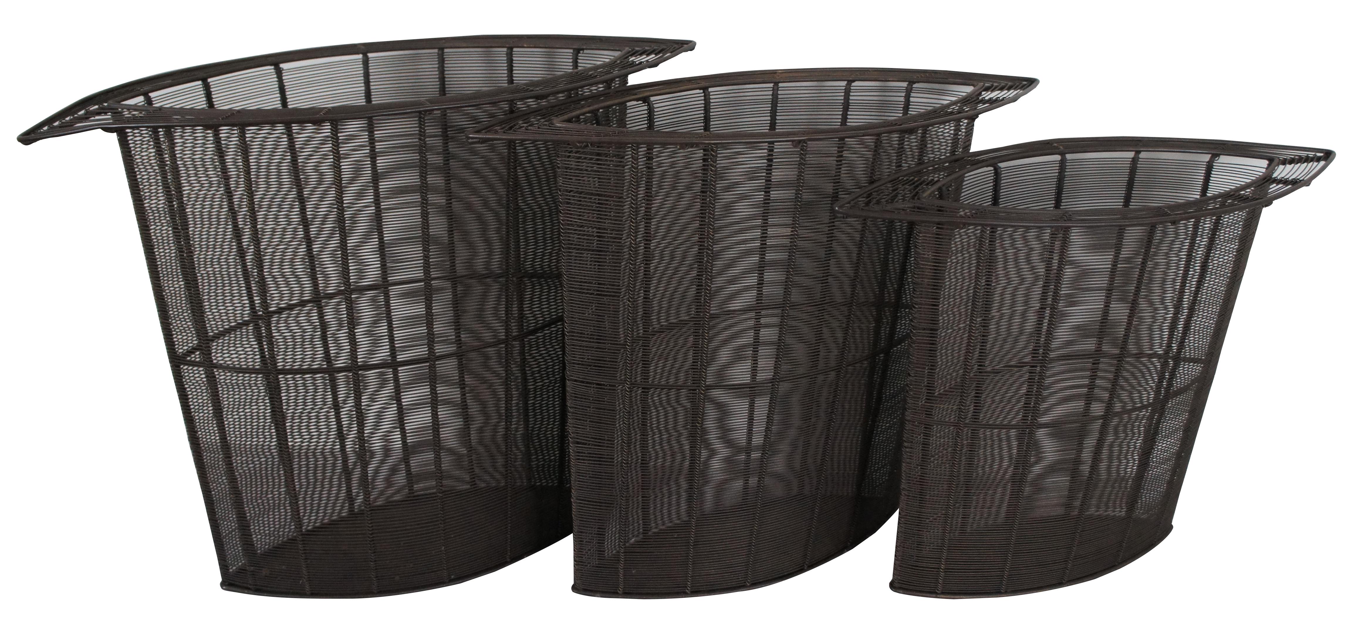 Set of three heavy oval shaped multi functional nesting baskets, displays or cane / umbrella stands, fashioned of gray-brown wire with wide rims, fashioned for Interlude Home Inc.

Small - 22” x 8” x 17” / Medium - 23.5” x 9.5” x 19” / Large - 25”
