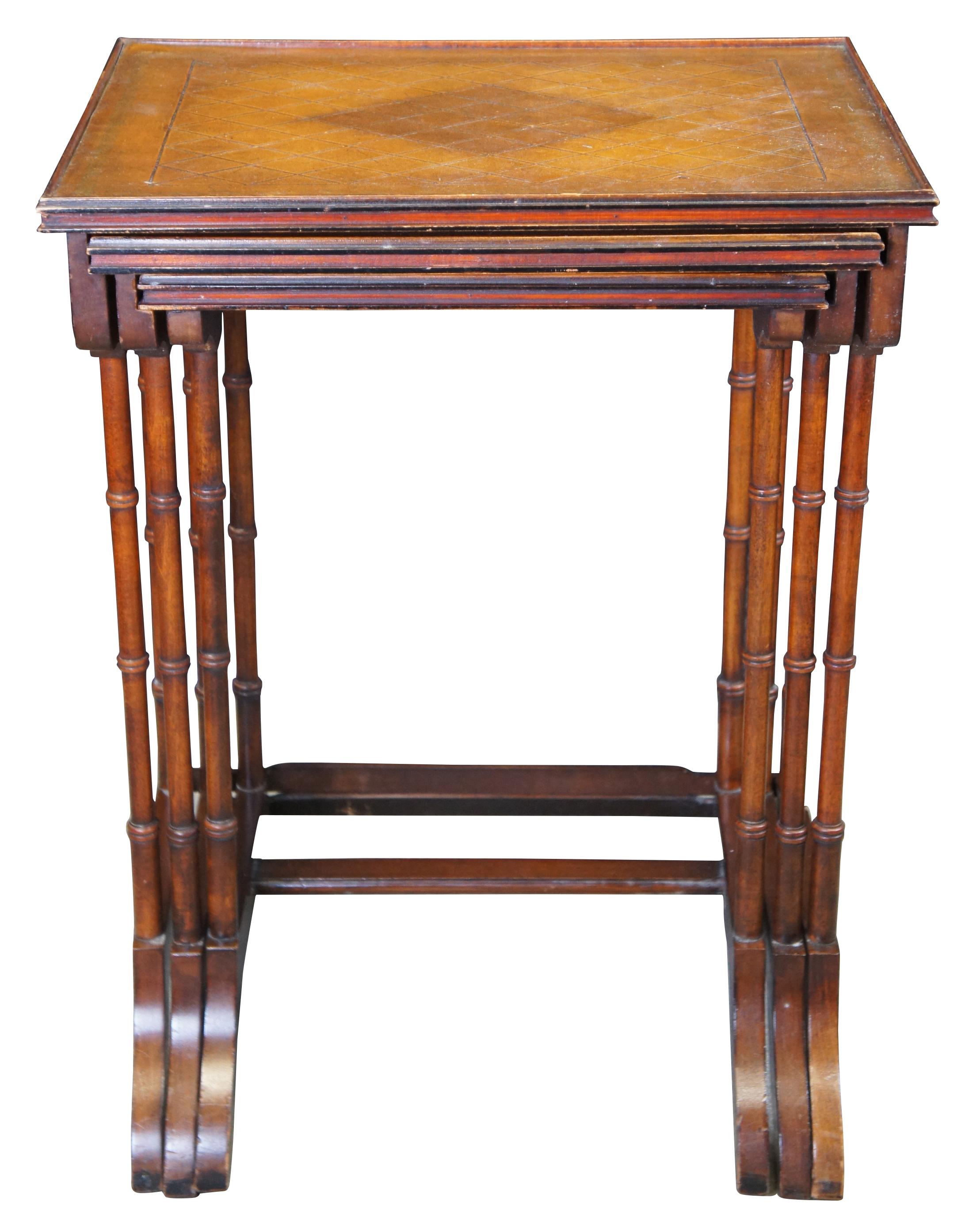 Nest of three mid-century Regency side or accent tables. Made of mahogany with tooled leather tops. Featuring a rectangular form diamond lattice pattern along largest table, bamboo style legs, and serpentine feet.

Measures: large - 18