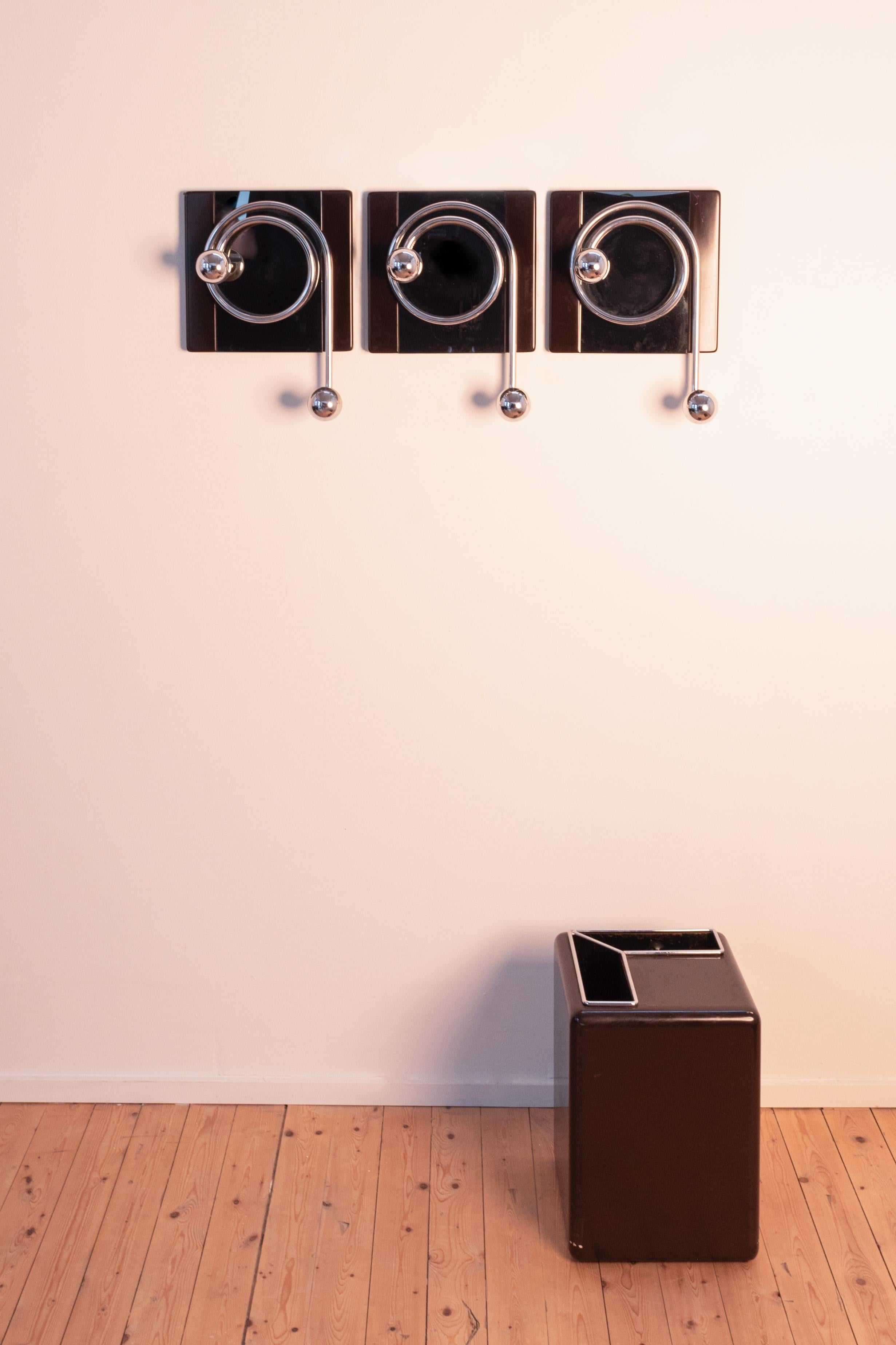 Rare set of 3 coat racks and umbrella stand, made in the 1970s in Italy. Designer: Willy Rizzo. 
Materials used: bakelite with chromed metal. Wear consistent with age and use. 