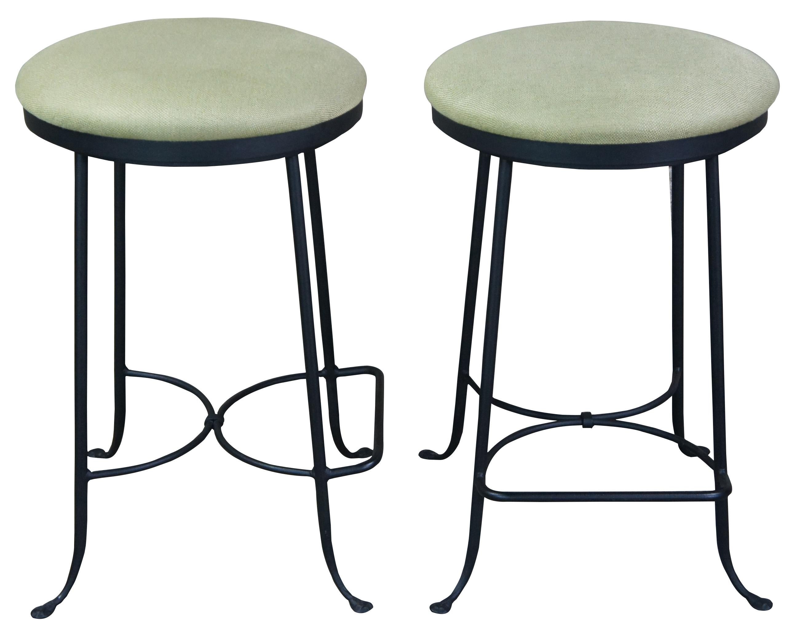 Three vintage Hearthstone Ent., Inc bar or counter stools featuring swivel seat with green upholstery and heavy sturdy wrought iron frame with foot rest. Made in Boone, North Carolina. Measure: 27