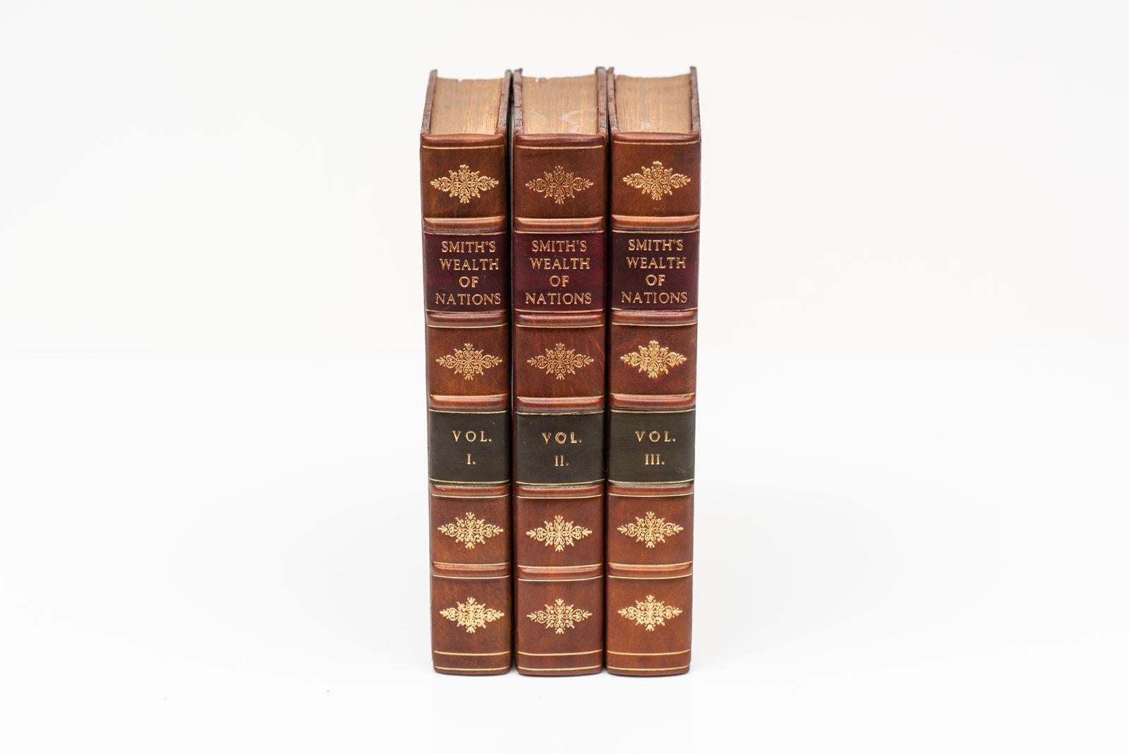 3 Volumes. Adam Smith, Wealth of Nations, with a life of the author. Fifth Edinburgh Edition. Bound in full tan calf with gilt-tooling on the covers and raised band spines. Spines rebacked. Edinburgh: Silvester Doig, 1818.