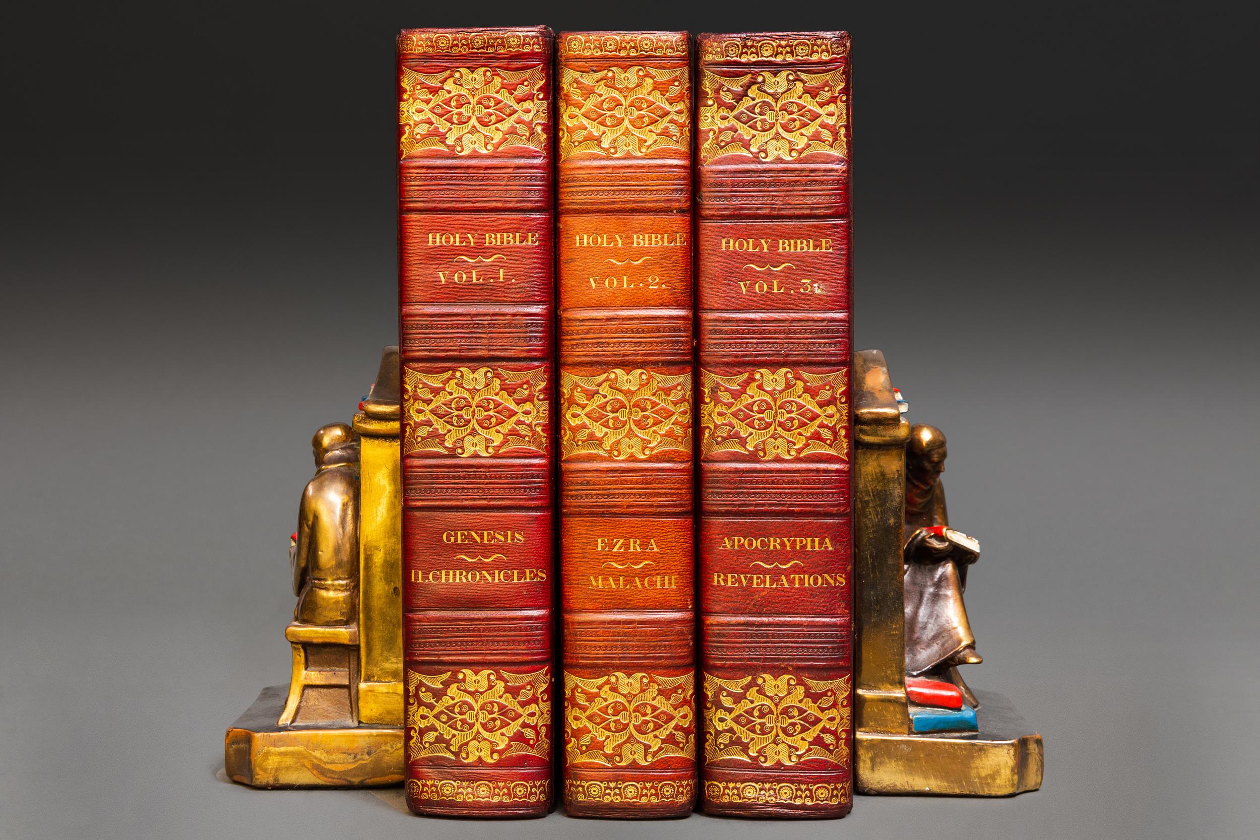 3 volumes. The Holy Bible- containing the old and new testaments. Bound in full red morocco. Decorative gilt-tooled pattern on covers. Decorative gilt on spines. All edges gilt. Cork endpapers. Raised bands. Translated out of the original tongues.