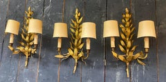 3 wall lights in the style of Maison Baguès in brass Stylized leaves