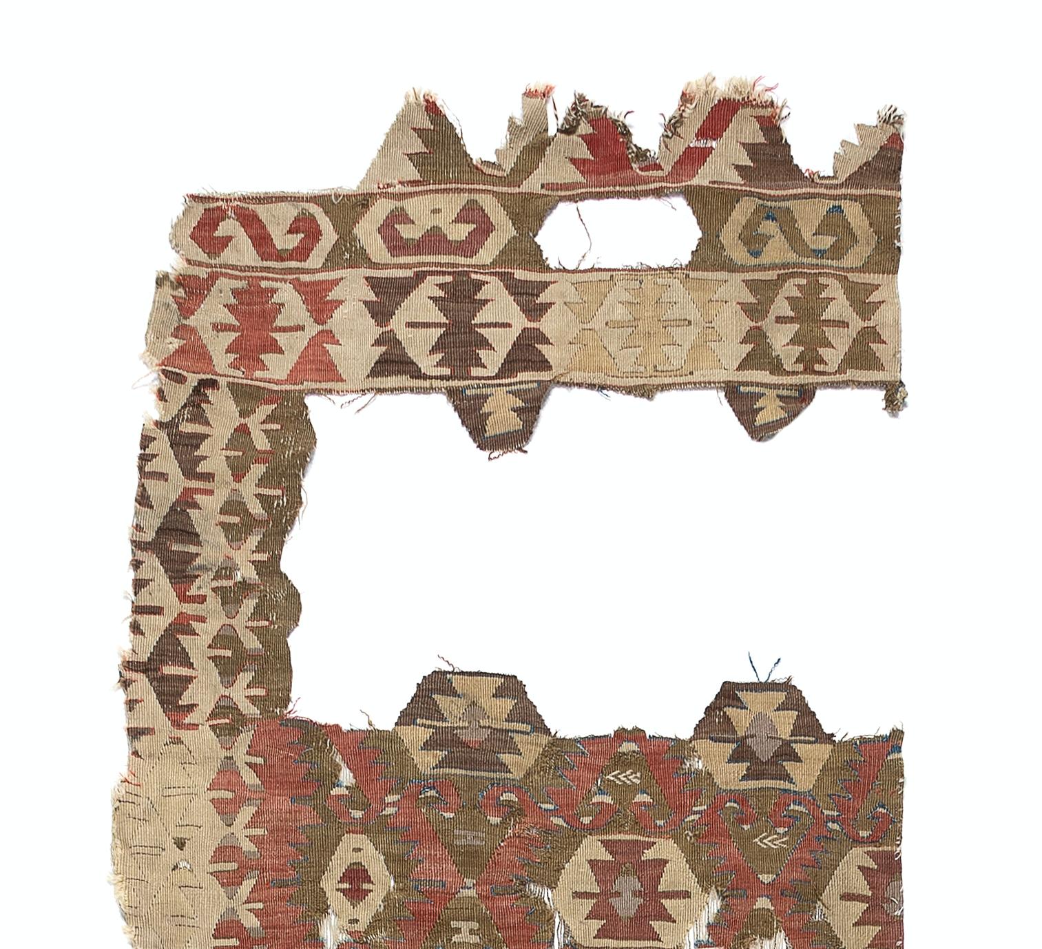 Embark on a journey through time and tradition with this exquisite Antique Anatolian Sivrihisar fragment distressed kilim, a rare artifact dating back to the 18th century. Crafted with meticulous skill and artistry by Anatolian weavers over three