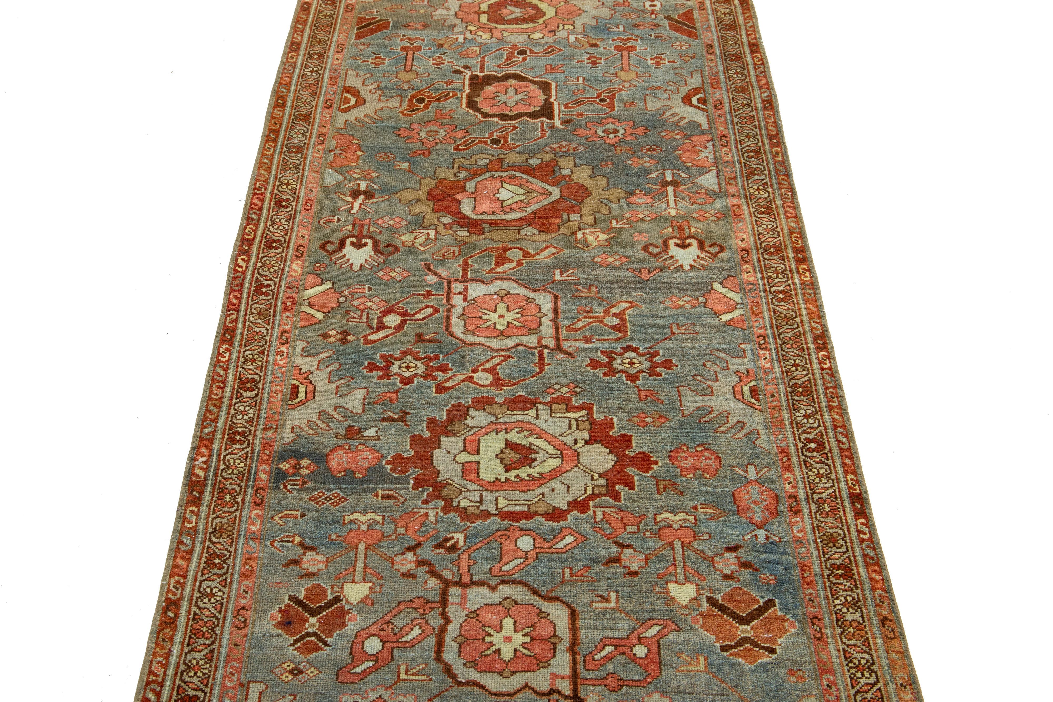 This beautiful 20th-century Heriz hand-knotted wool runner has a blue field. The piece features stunning multicolor accents in a gorgeous floral design.

This rug measures 3' x 13'9