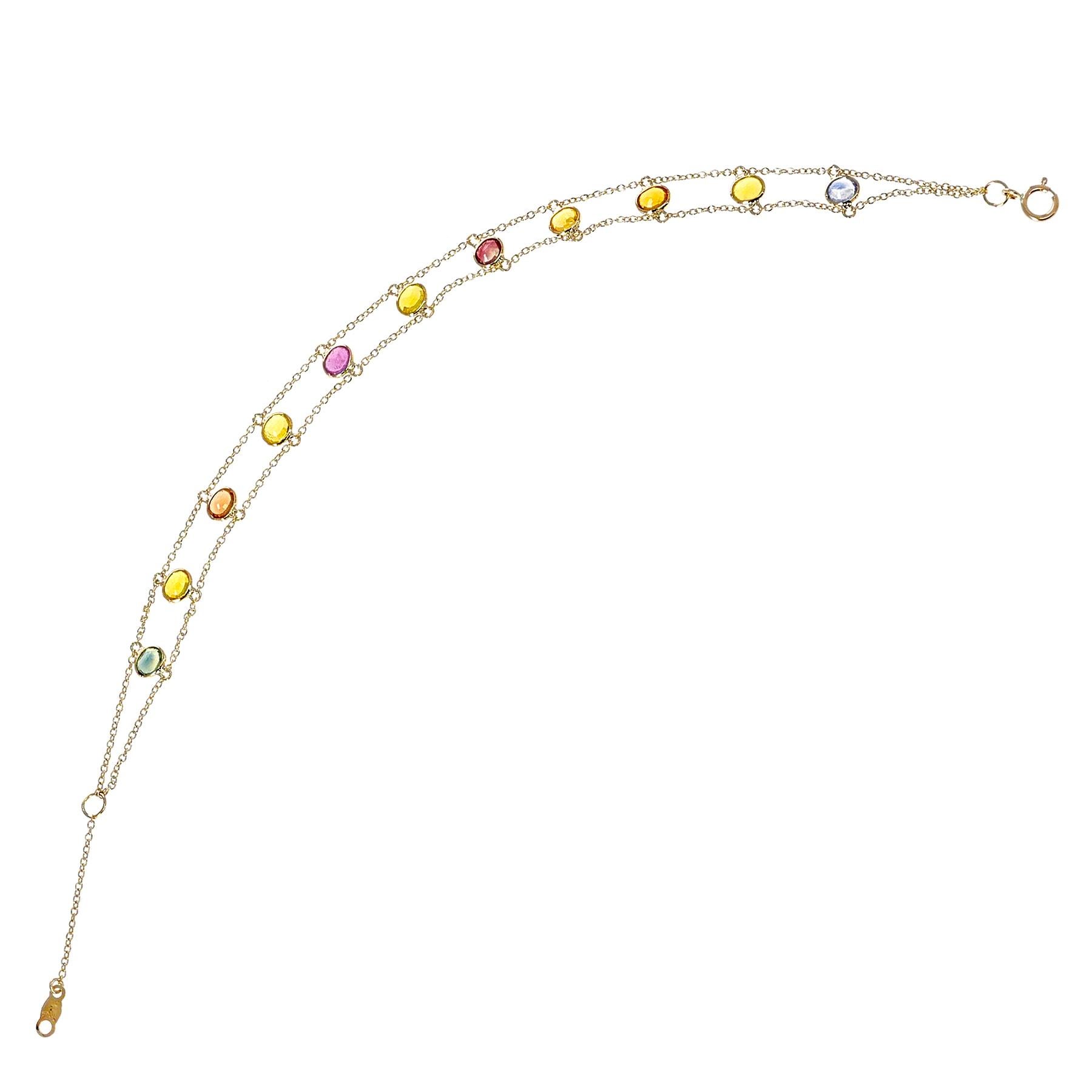 A 3 x 4MM Oval Genuine Multi-Sapphire 18k Yellow Gold Adjustable Bracelet. The length of the bracelet is 7.50.