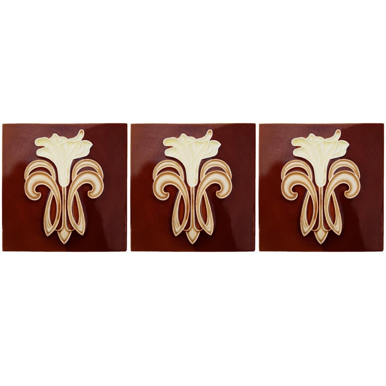Recently lifted from its original home, a set of antique tiles from the early 20th century. With a beautiful stylized design of a lily.
Manufactured by Gilliot Fabrieken te Hemiksem.

Size each tile: inches 5.9 inches (15.1 cm) width x 5.9 inches