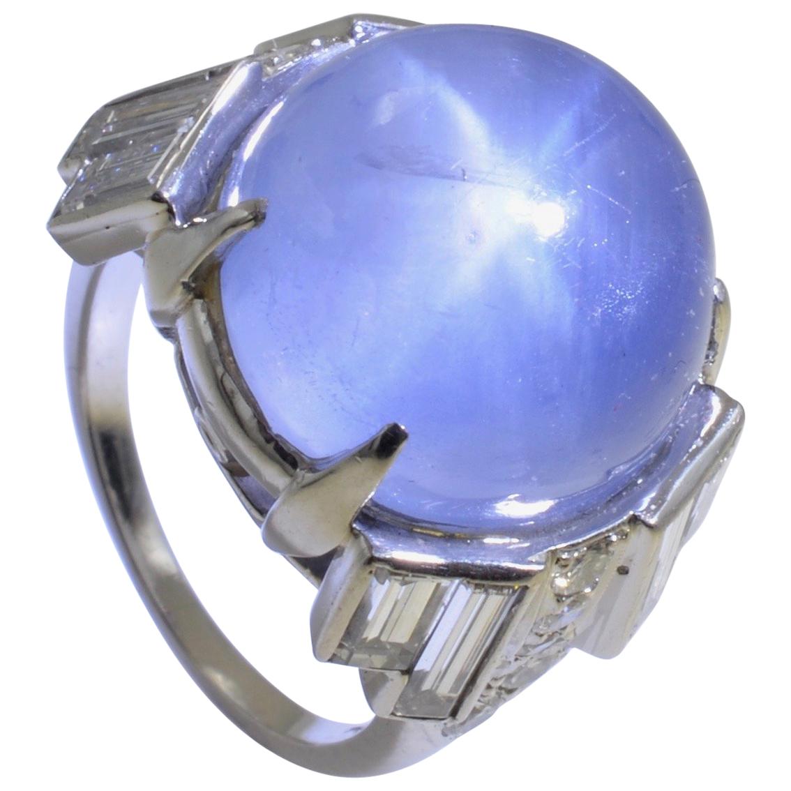 30 carats blue denim color sapphire cabochon with a very distinguish Star, surrounded by the most elegant baguettes. The diamond over sized total weight approximately 1.60cts and quality GVS . This piece in platinum is the epitome of the 60's