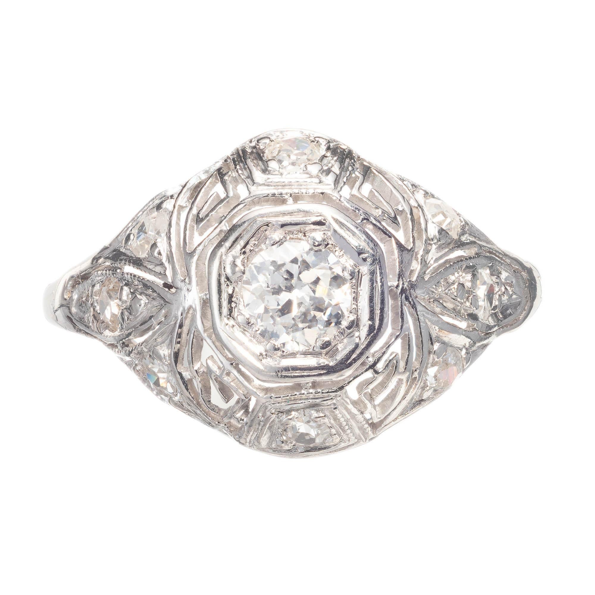 Diamond platinum Art Deco engagement ring. Center diamond is bezel set on top of a filigree style dome platinum setting. with smaller antique single cut diamonds set occasionally around ring. 

1 Old mine cut G-H SI2 diamond, Approx. .30 carats EGL