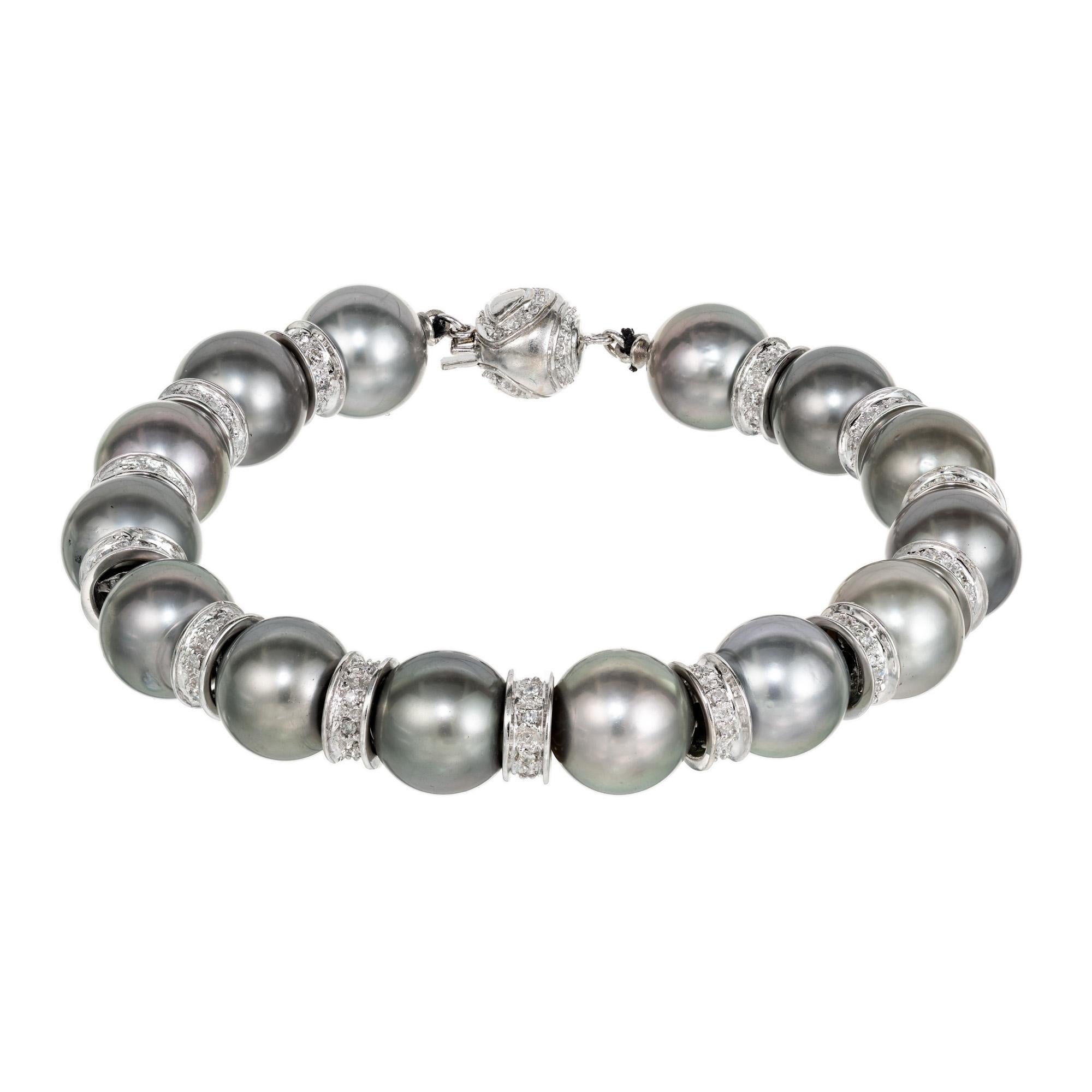 South sea pearl and diamond bracelet. 14 beautiful gray black South Sea 10mm Pearls have an exceptional rich a gray color. Separated by 14k white gold round spaces with 116 round cut diamonds including a 14k white gold diamond ball clasp. Fits a 7.5