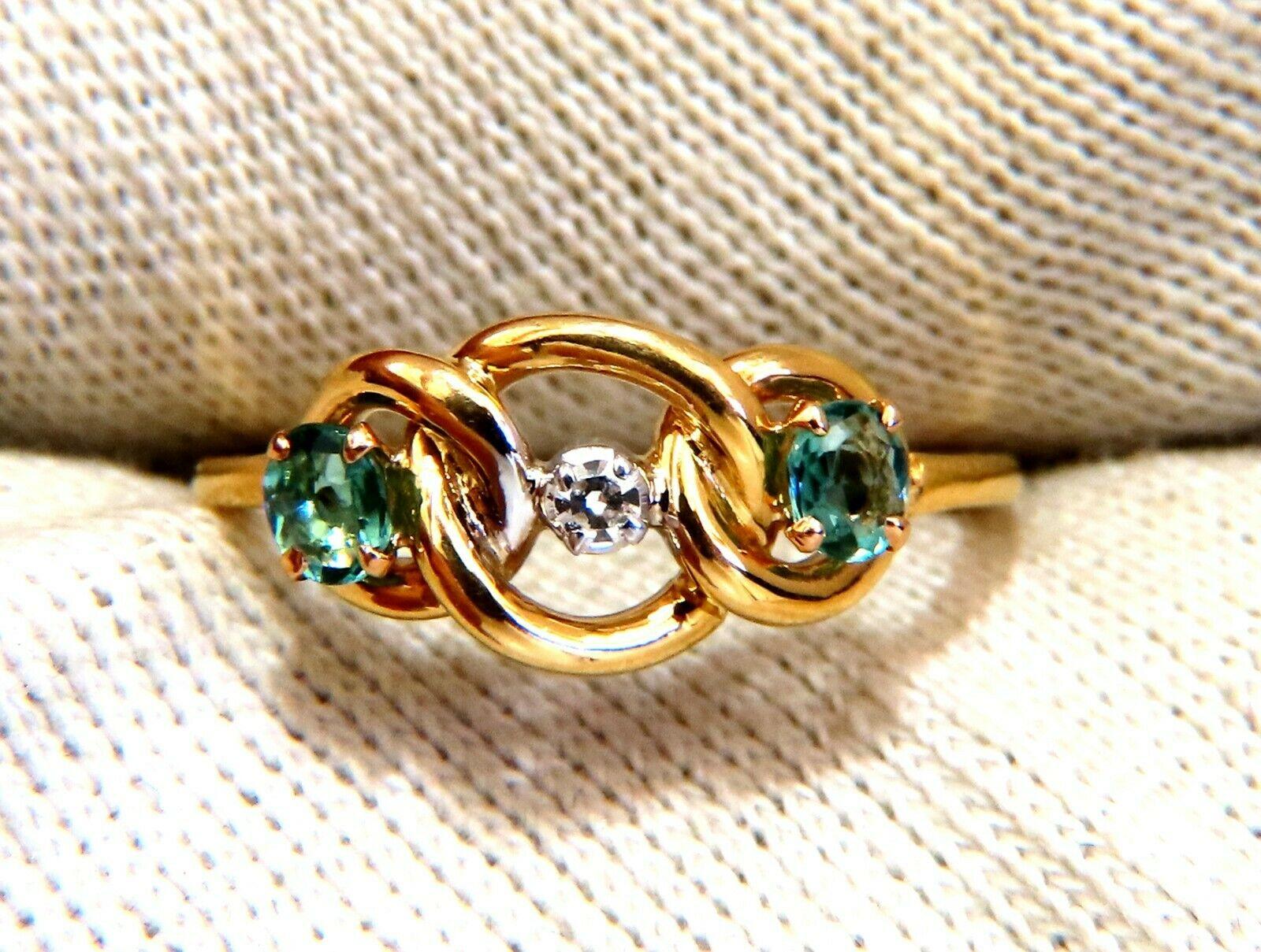 Infinity green aquamarine ring

.30 carat natural green aquamarines

.05 carat natural diamond

18 karat yellow gold 2.5 g

Ring is 8 mm wide

Depth 3 mm

Current size 6.5 and we may resize please inquire