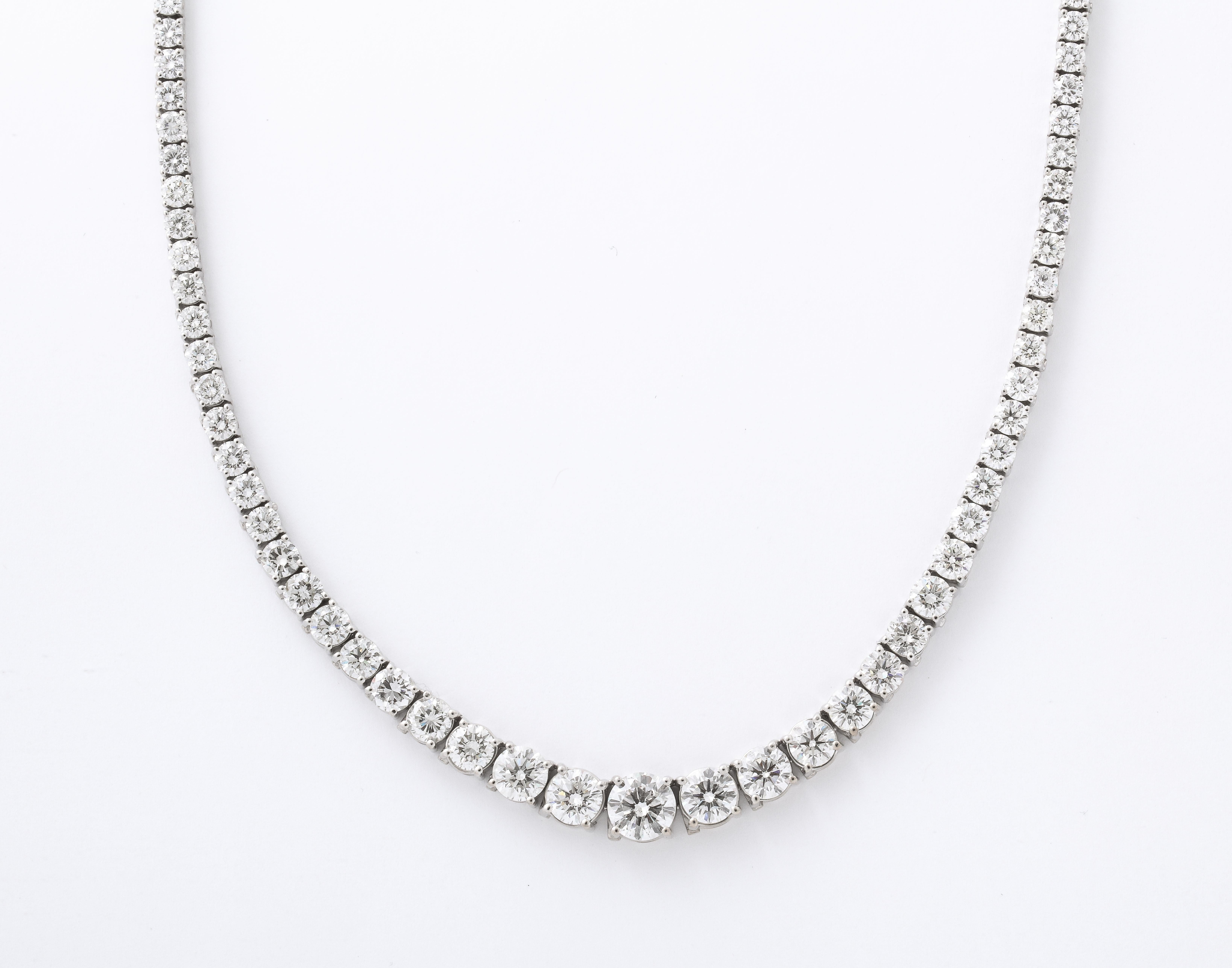 
A fabulous riviera tennis necklace set in 18k white gold. 

A total of 30.04 carats of white round brilliant cut diamonds with a 2 carat center stone. 

17 inch length. 
