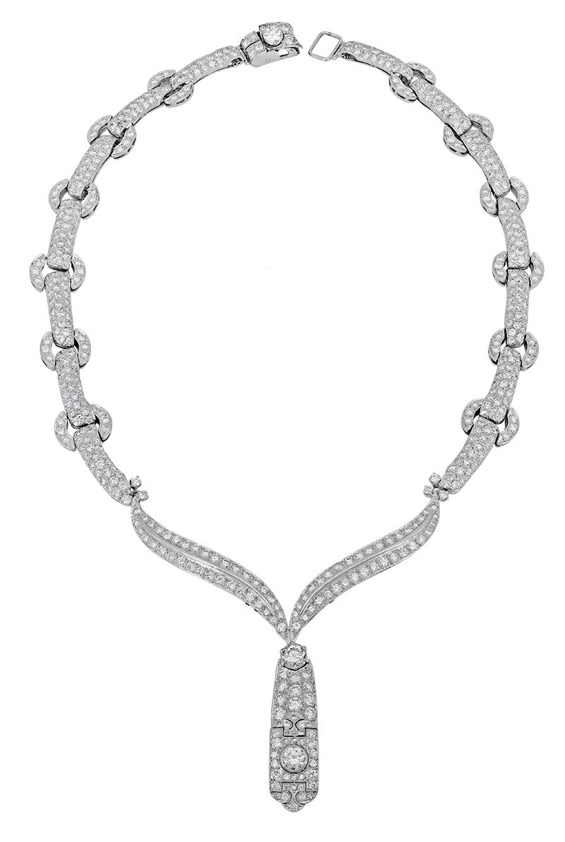 A simple statement piece showcasing diamond encrusted links made in 18k white gold. An intricately designed pendant elegantly drops from the necklace and is set with more brilliant diamonds. The drop pendant is detachable and can be removed. 
Length