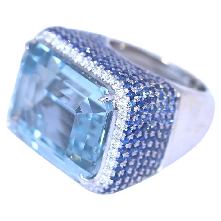 Diamond Ring with a 30Ct Aquamarine and 3Ct Sapphires. Massive and fine ring perfectly representing the 1990es. The color of the Aquamarine is just mesmerizing. It is an oversized statement of fashion. Clearly an attention-grabbing ring whenever and