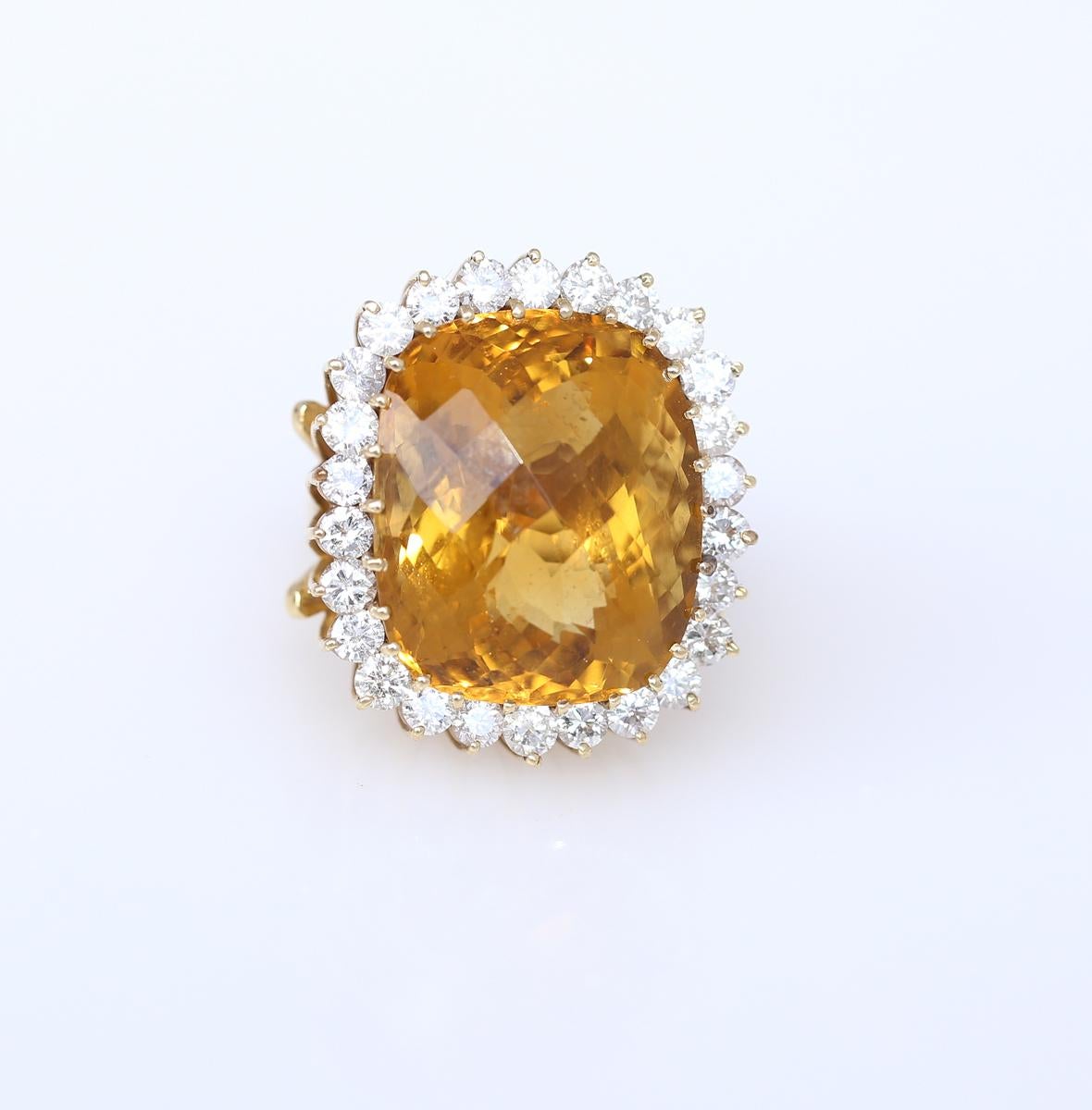 Fine and bright Citrine of 30 Carats and 1 Carat of fine diamonds surrounding the centre stone form a magnificent ring. The spectacular massive ring will grab attention at any occasion, cocktail party or gala. It is a great example of the 80es era