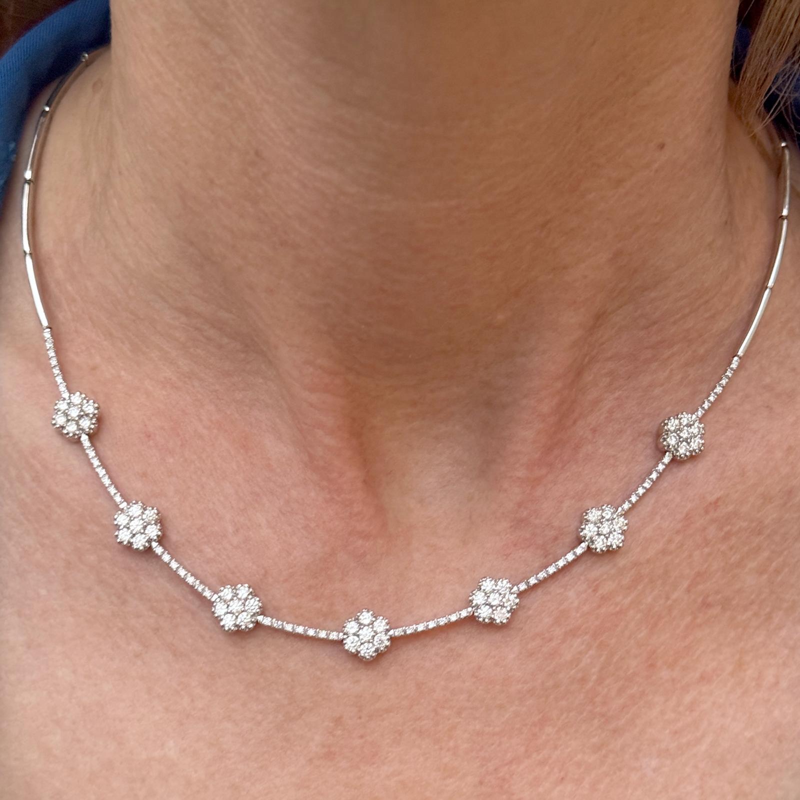 Modern and feminine diamond cluster necklace crafted in 18 karat white gold. The necklace features round brilliant cut diamonds weighing approximately 3.00 carat total weight. The diamonds are graded G-H color and VS2-SI1 clarity. The necklace