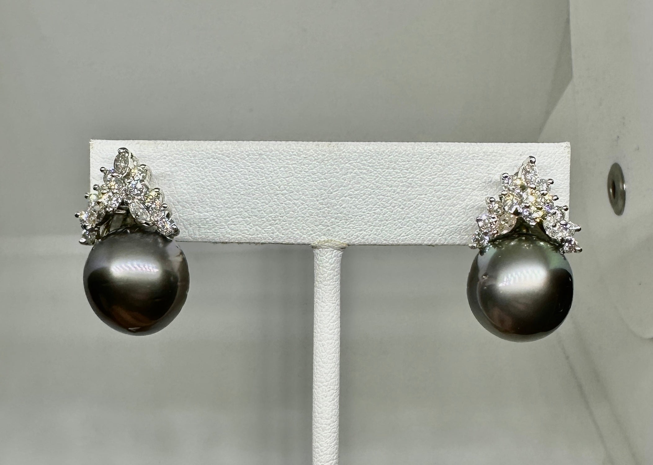 Indulge in a magnificent pair of Antique Diamond and Black South Sea Pearl Earrings with 30 gorgeous marquise and round Diamonds set in 14 Karat White Gold.  The extraordinary Hollywood Regency style earrings are a dramatic 1 inch (26mm) long.  The