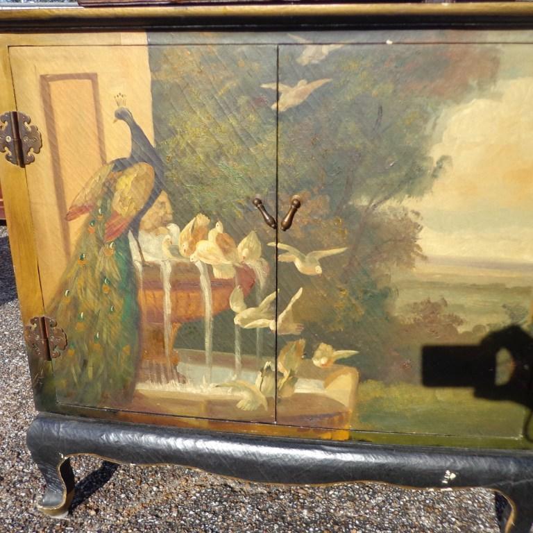 30? Ebonized cabinet painted with peacock.


Charming two door roomy cabinet in the style of Maitland Smith featuring a country landscape with peacocks and other birds.