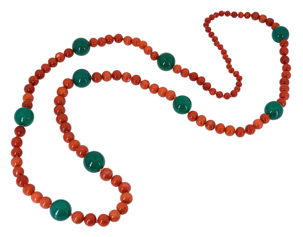 These Red Coral and Onyx beads were purchased as part of an estate before being made into this contemporary 30 inch Red Coral and Green Onyx Necklace that has nine 12 mm round Green Onyx Beads that stand out from the smaller rich, round Red Coral