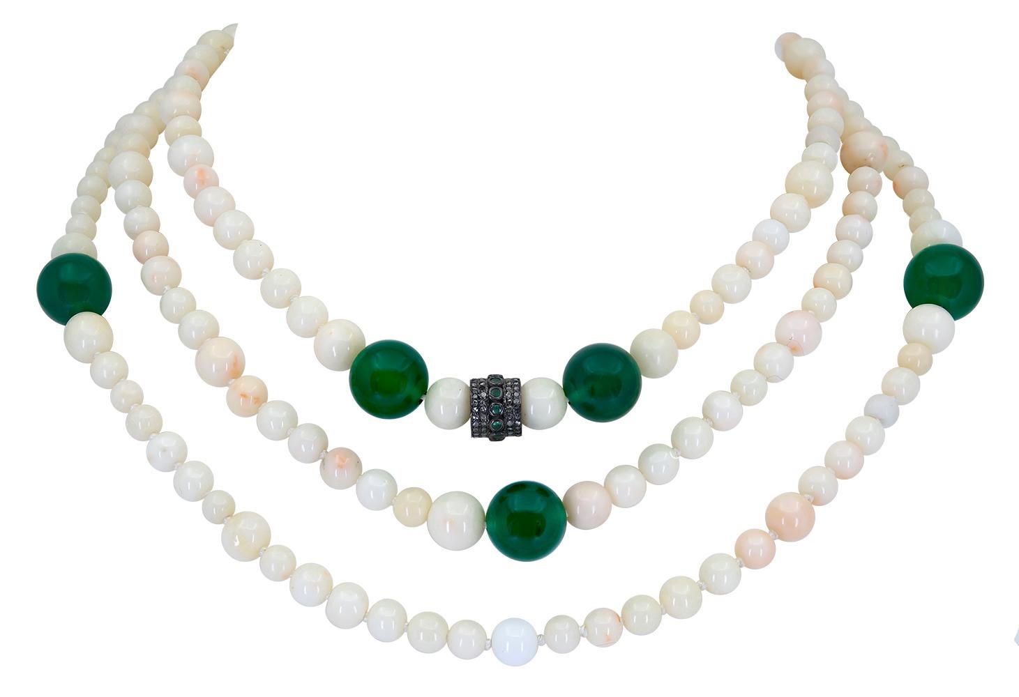 A 30 inch White Coral and Green Onyx Necklace that features 9 round translucent Green Onyx Beads that measure, as an average, 12.5 mm. These rich green onyx beads stand out in beautiful contrast from the round, natural white coral beads that