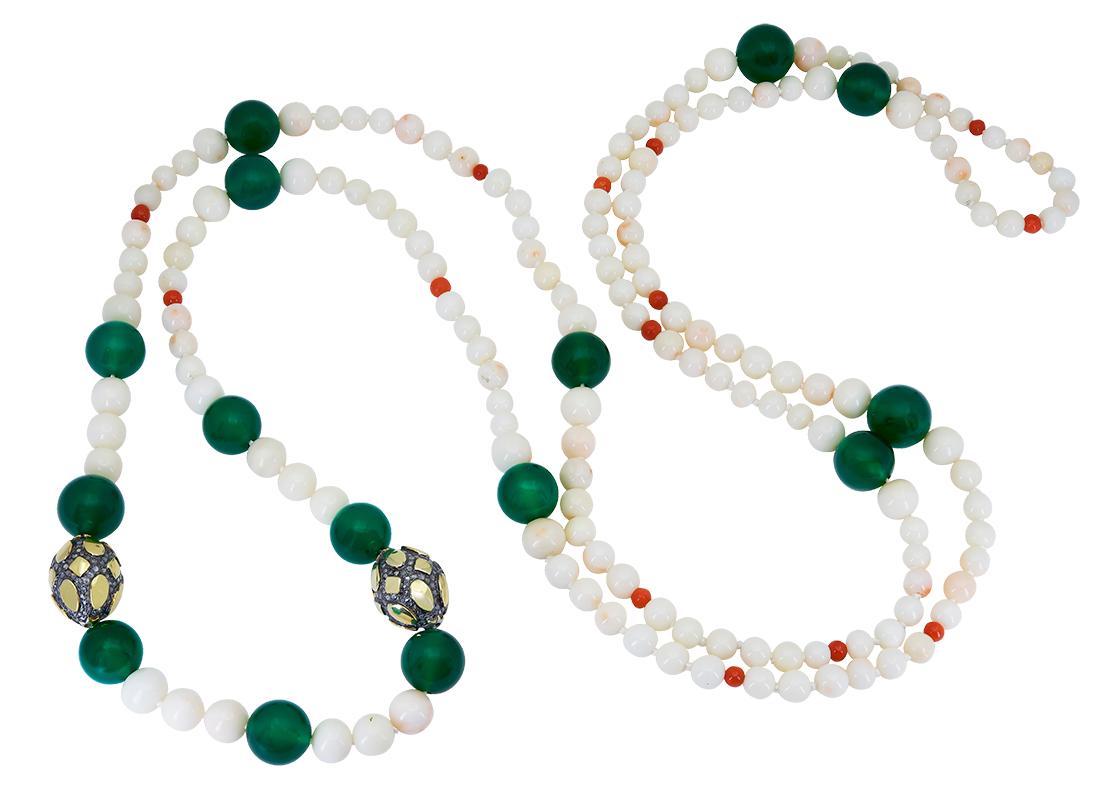 A 30 inch White Coral and Green Onyx Necklace that features 15 round translucent Green Onyx Beads that measure, as an average,12 mm. These rich green onyx beads stand out in beautiful contrast from the round, natural white coral beads that graduate