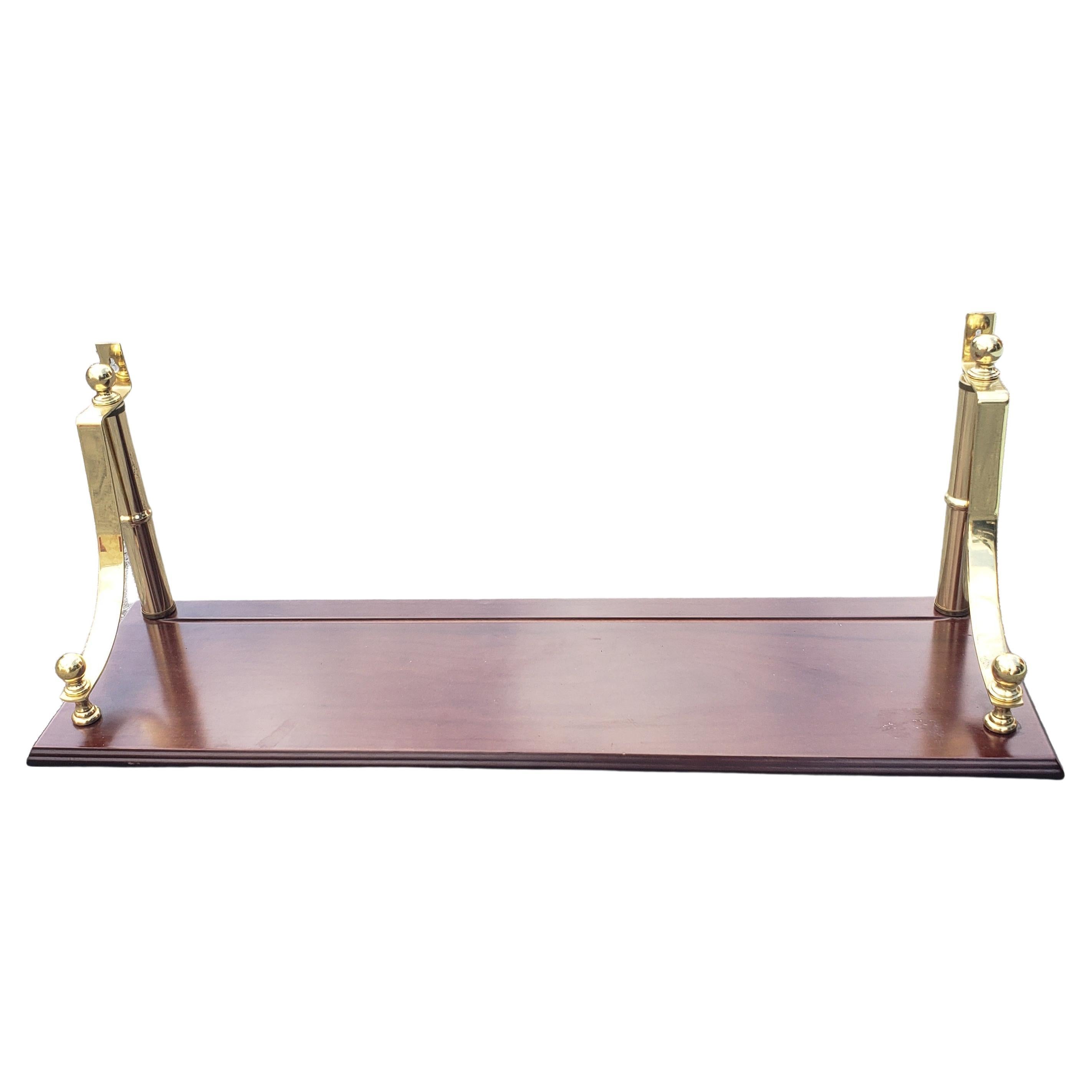 A Solid Mahogany and Brass Mounted Wall Shelf.
Measuring 30 inches in width, 8.5 inches in depth and 11.5 inches in height.
