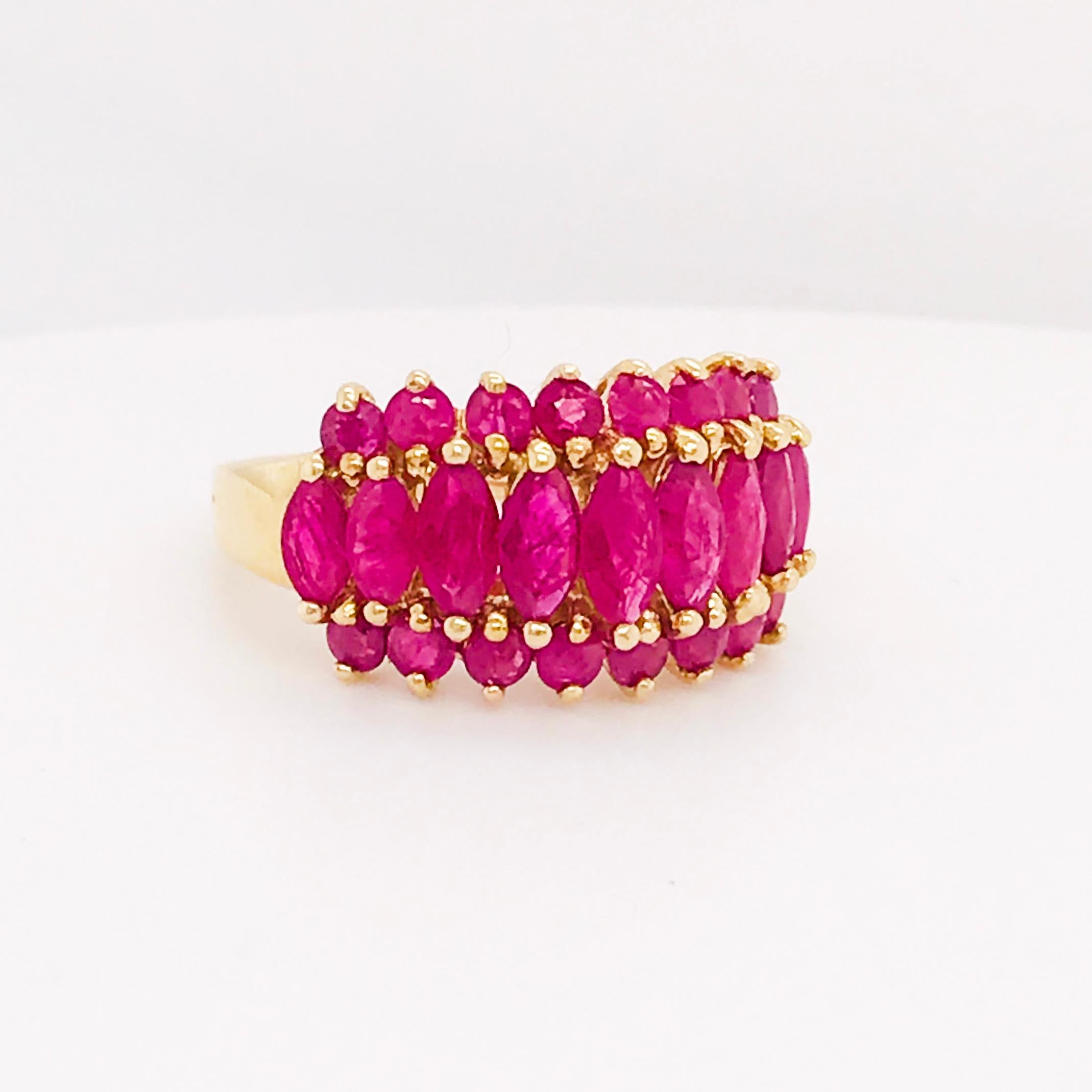 This genuine 3 carat ruby gemstone ring is vibrant in color and character! The custom design is a unique cluster made of bold ruby gemstones of different shapes - marquise and round. The bright ruby red is set in a rich yellow gold. This yellow gold