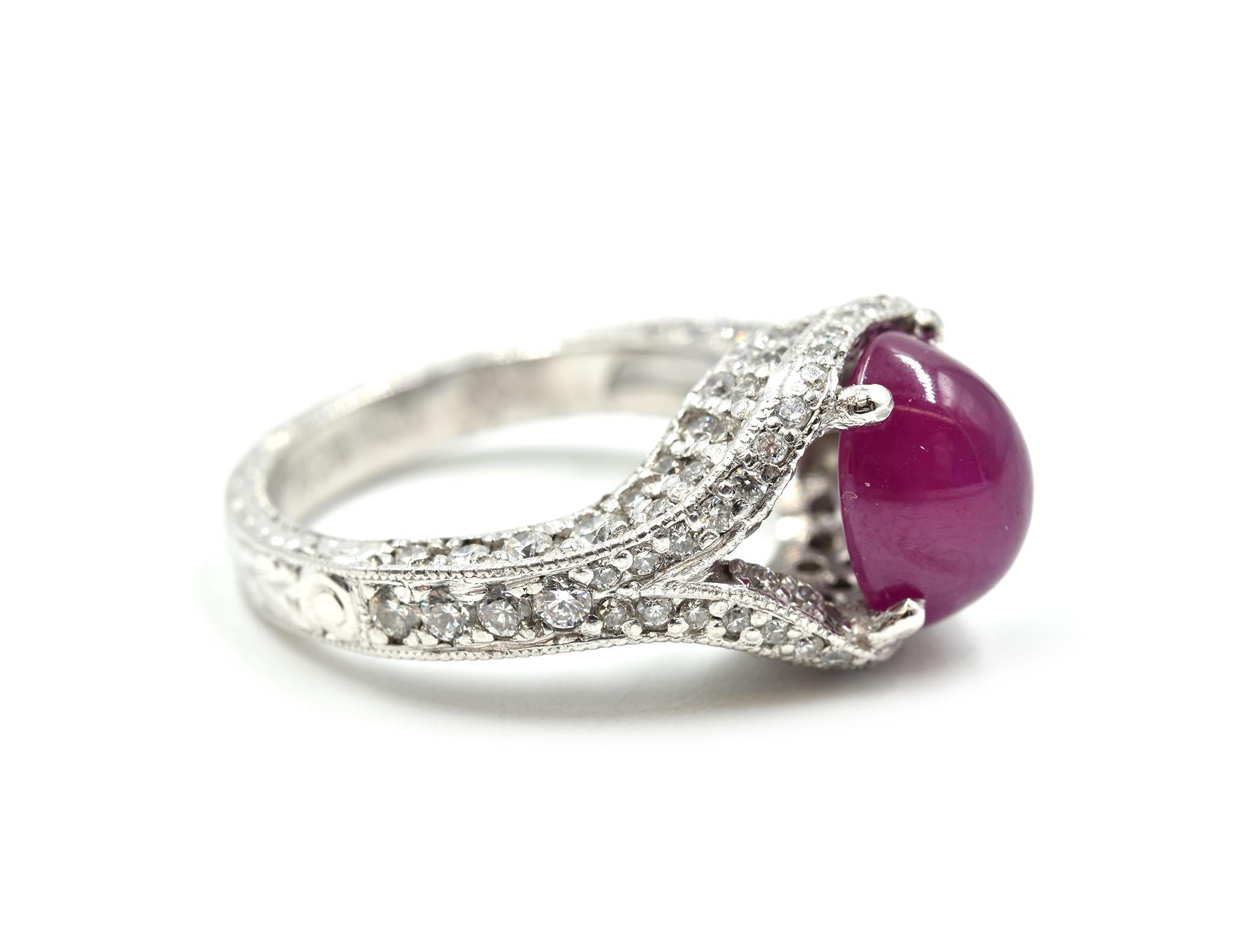 Designer: custom design
Material: platinum
Ruby: one cabochon cut ruby 3.00 carat weight 
Diamonds: 110 round brilliant cuts = 1.60 carat total weight
Color: G
Clarity: VS
Dimensions: ring top is 3/5-inches long
Ring Size: 4 ¾ (please allow two