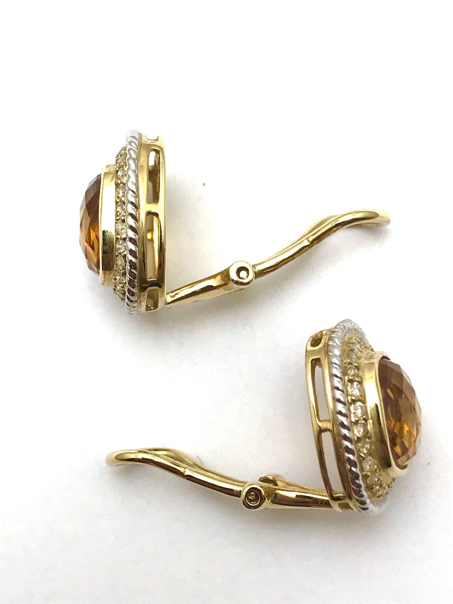 A pair of 3.00 carats total weight pillow cut citrines and diamonds in 14 karat white and yellow gold clip earrings.  The earrings are designed with the bezel set citrine centers, surrounded by a single row of round brilliant diamonds, and framed by