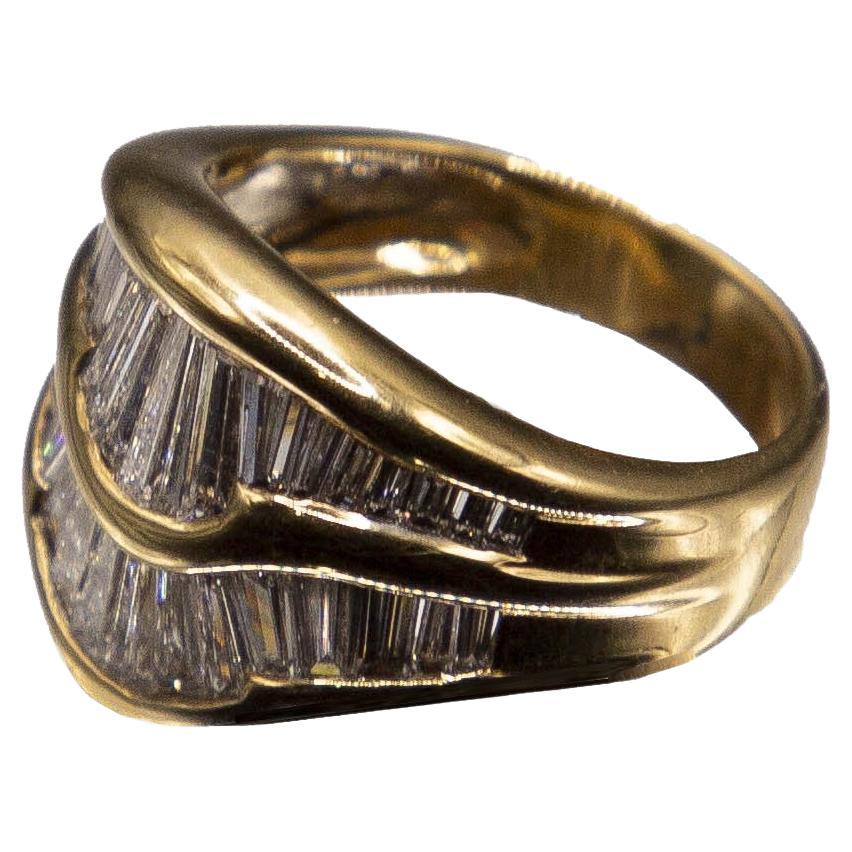A handcrafted one-of-a-kind 18kt yellow gold cocktail ring set with two rows of swirling, top-collection quality tapered baguette diamonds. Each of the 40 French hand- cut baguettes are flush channel -set, providing true comfort in wear, with