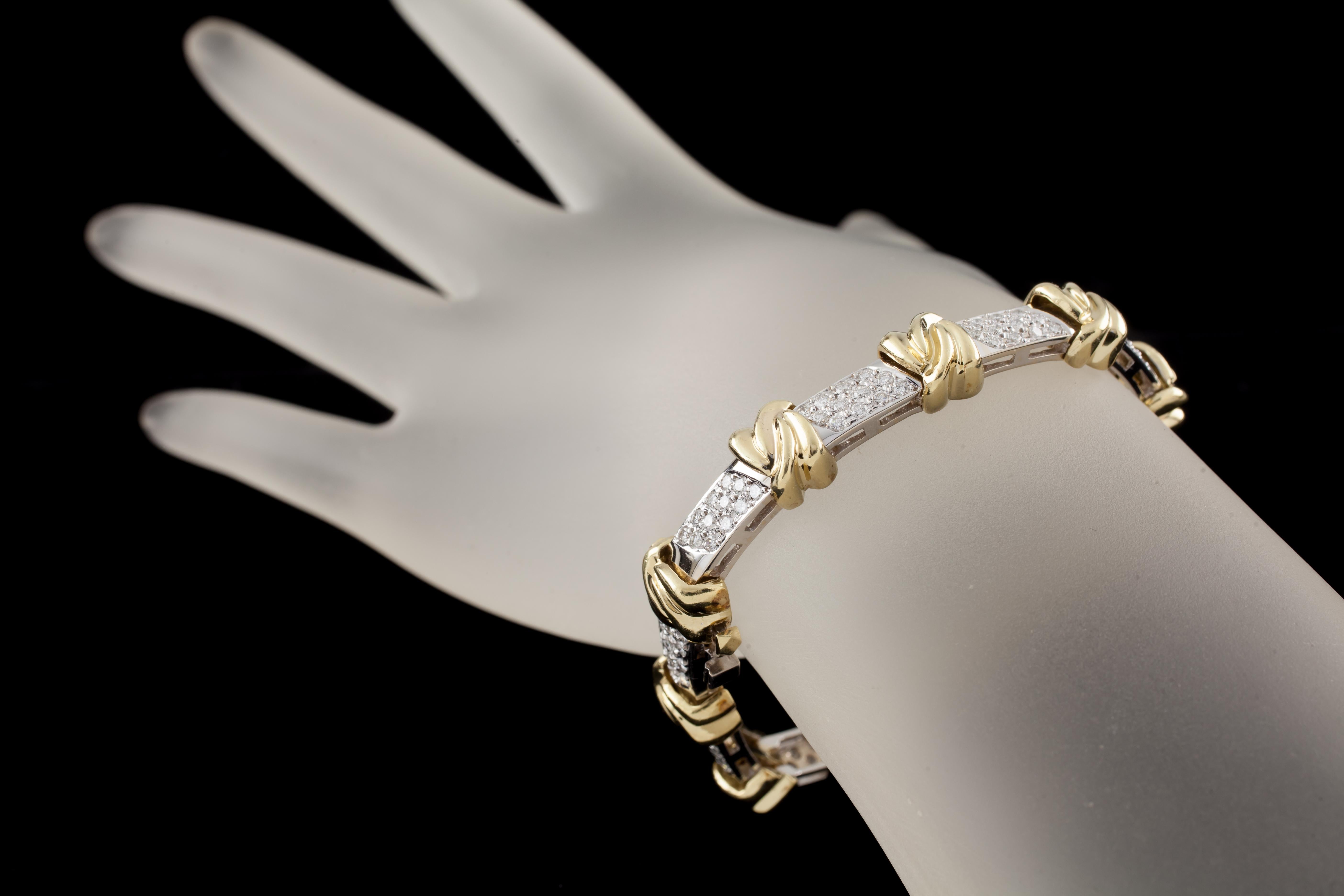 Set in 18k Yellow & White Gold
12 Diamonds (13 in the last station) in each White Gold Station separated by Yellow Gold Knots
Total Diamond Carat Weight: 3.00 carat
Diamond Clarity Grade: VS
Diamond Color Grade: G
Total Weight: 41.3 grams
Bracelet