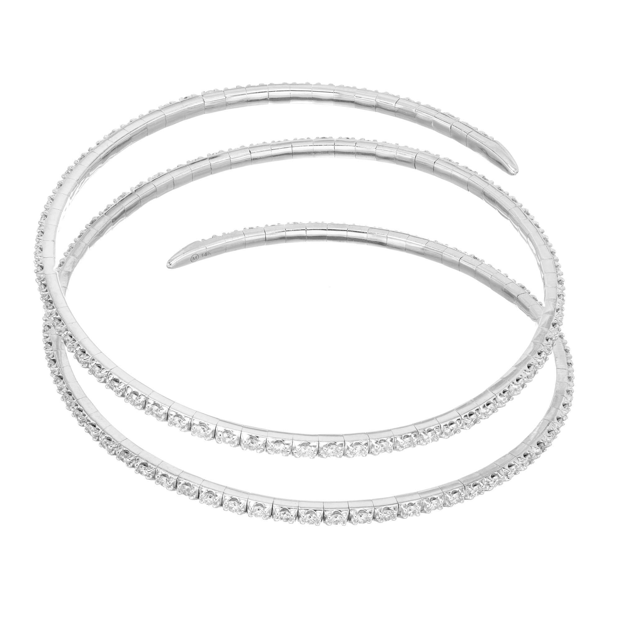 Coiled slip on 14k white gold 3.00 carat full cut diamond bracelet

150 round brilliant cut diamonds H-I SI, approx. 3.00cts
14k white gold 
Stamped: 14k
Hallmark: M
19.8 grams
Width: 2.3mm
Thickness/depth: 2.5mm
Inside Dimensions: 2.5 Inches x 2.5