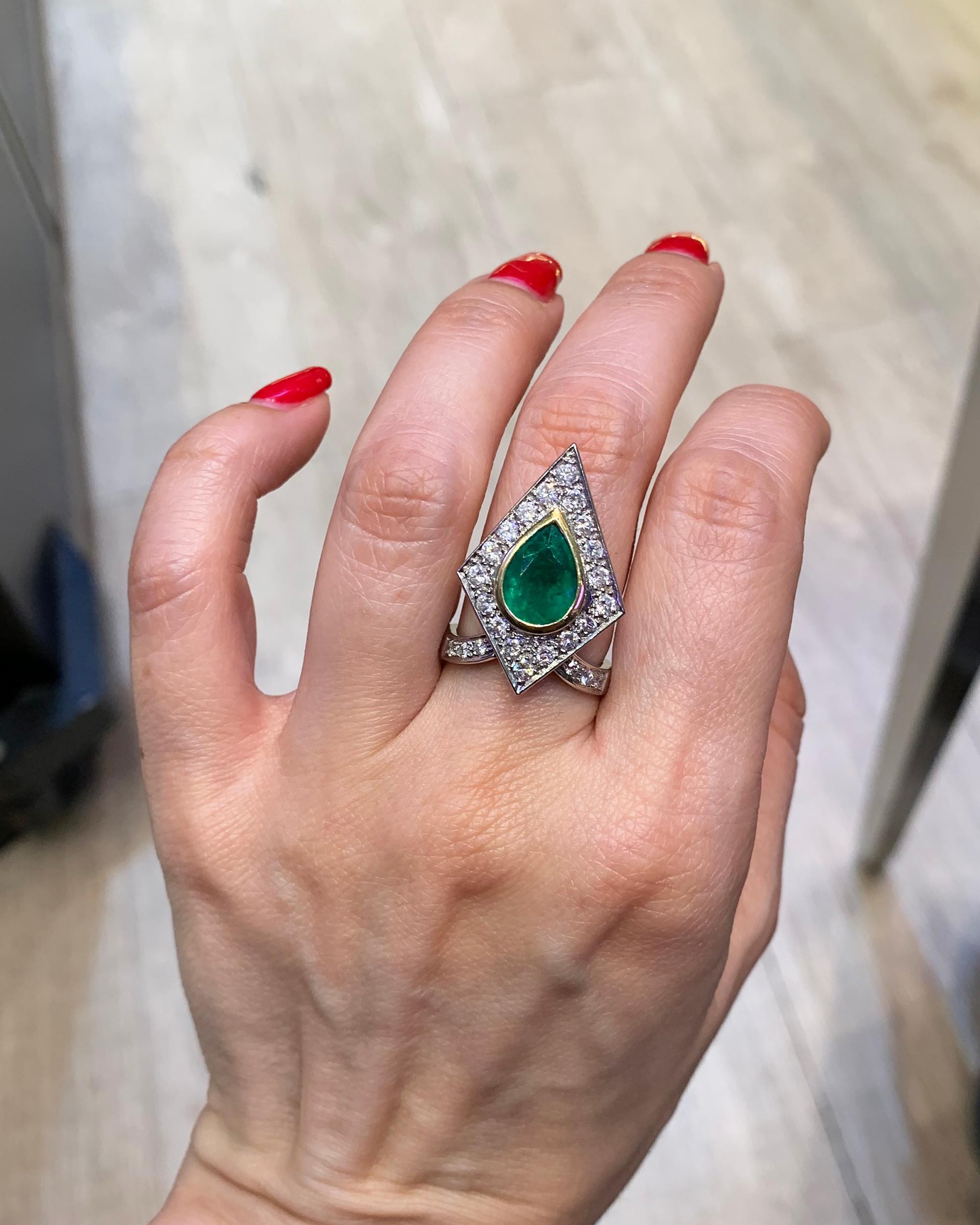 Made in the 21st century, circa 2010, this unusual emerald and diamond pyramid ring by Spectra Fine Jewelry is striking as a cocktail ring, engagement ring, or celebration ring. Crafted in platinum, the detailing of the ring is stunning, with a