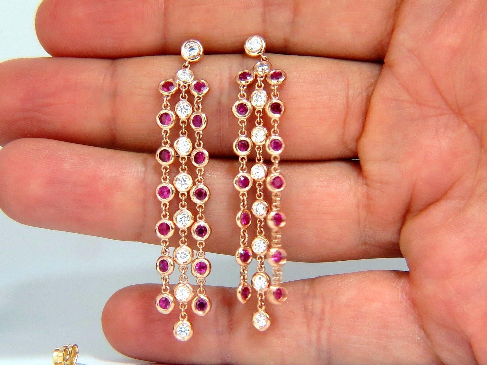 Ruby  & Diamonds By the Yard,  Dangling Earrings.

Three Tier.

2.00ct. Natural Rounds Brilliant cut Rubies.

Clean clarity, Deep Reds & Transparent.

Diamonds Total Weight: 1.00ct.

Rounds & Full cuts.

G-color vs-2 clarity.

14kt. rose gold

7.2