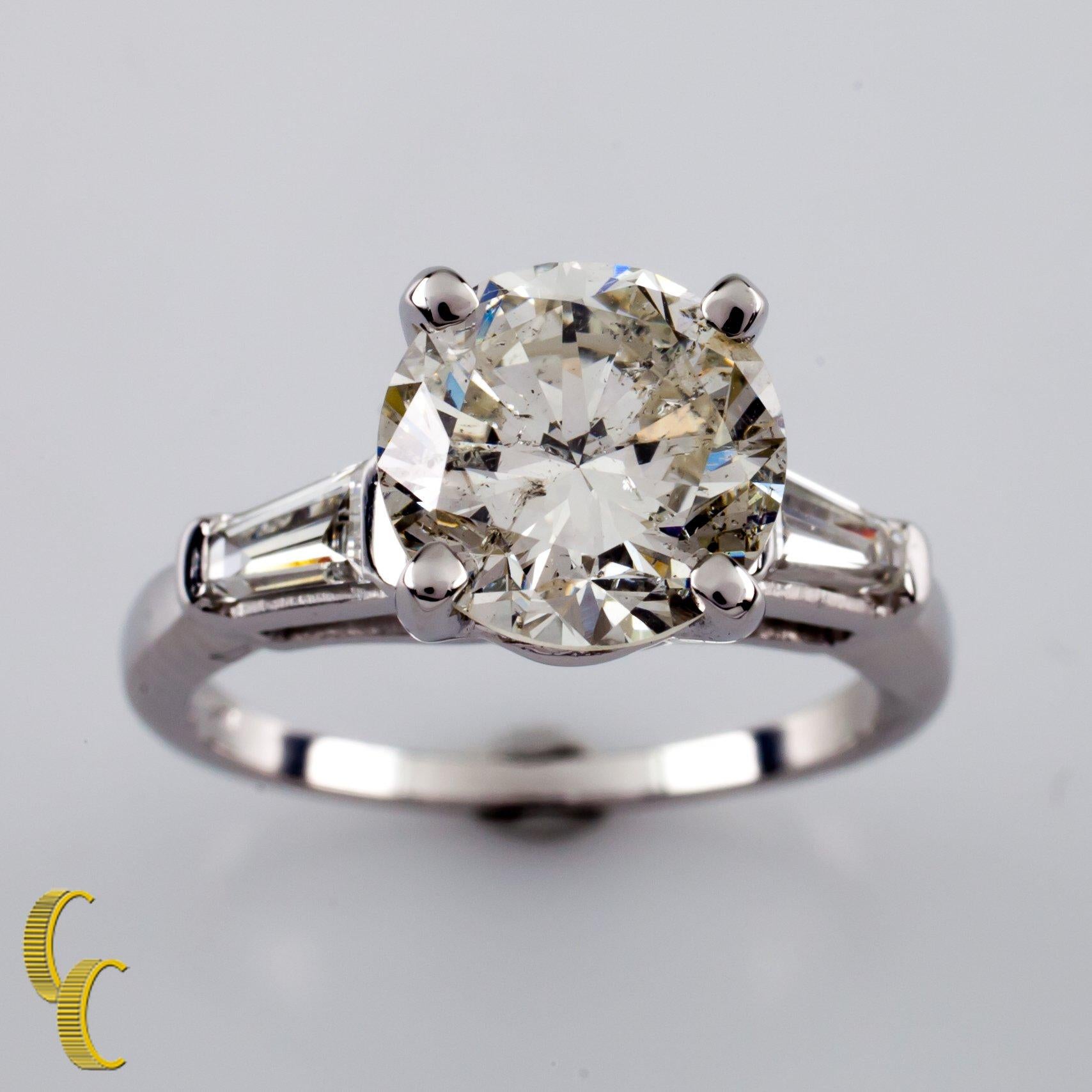 18 karat white gold setting 
Ring size = 6.25
Diamond Center Stone Specs:
Diamond Carat weight: 3.00 carats
Diamond Color Grade: I
Diamond Clarity Grade: I1
Total Mass: 6.5 grams